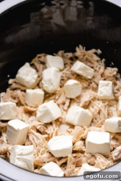 Cubed cream cheese added to crock pot