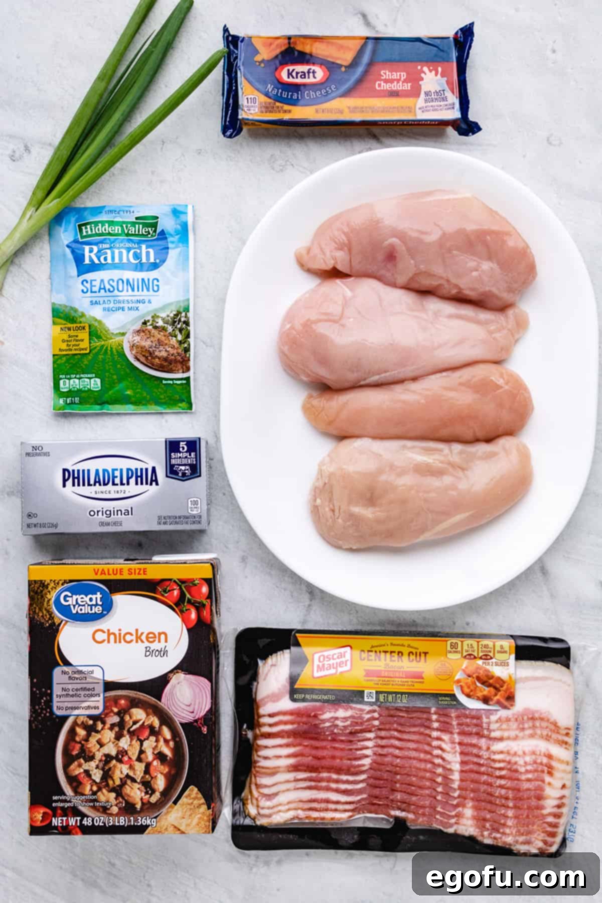 Ingredients needed to make Crock Pot Crack Chicken: chicken breasts, ranch seasoning, cream cheese, chicken broth, cheese, bacon, green onions.