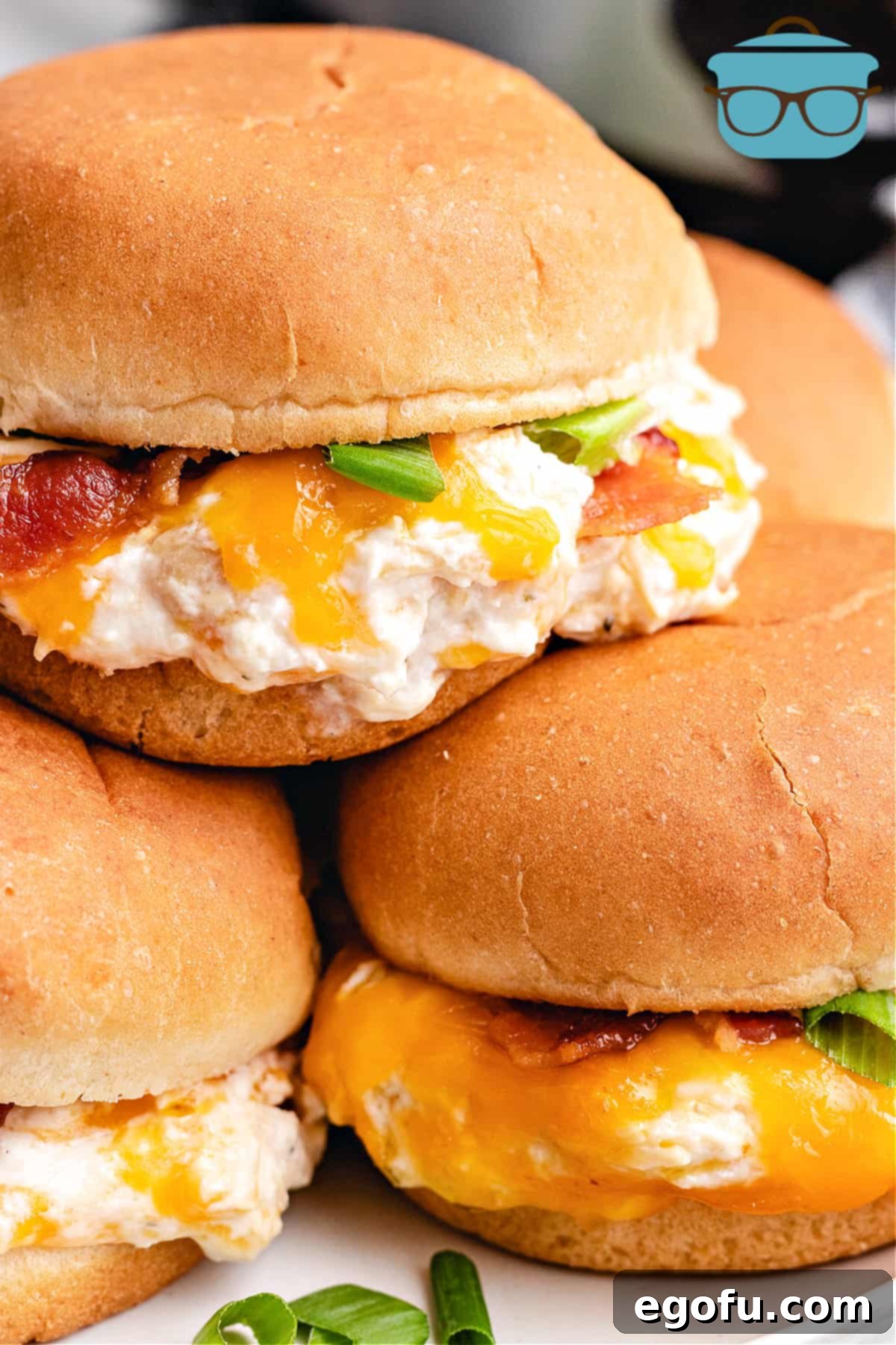 Crock Pot Crack Chicken on sandwich buns stacked.