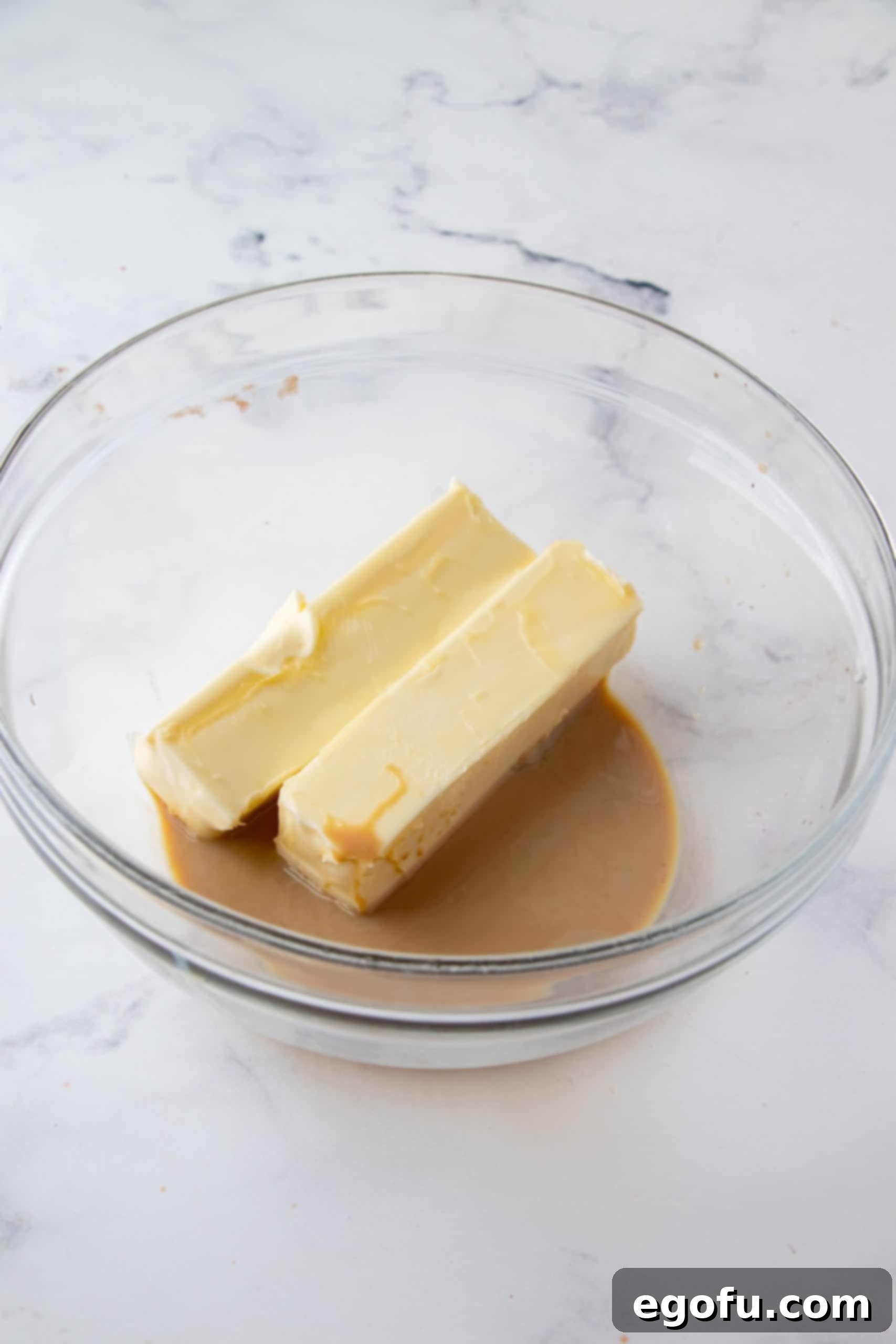 Decadent Baileys Cupcakes 11 Softened butter and Baileys Irish Cream being beaten together in a bowl, forming a smooth, creamy base for the frosting.
