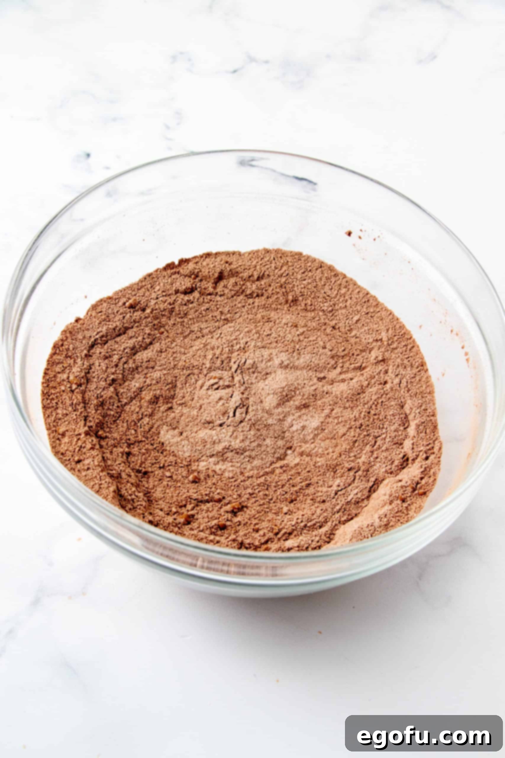 Decadent Baileys Cupcakes 6 Whisked dry ingredients in a bowl, now uniformly mixed and light brown in color, awaiting the addition of wet ingredients.