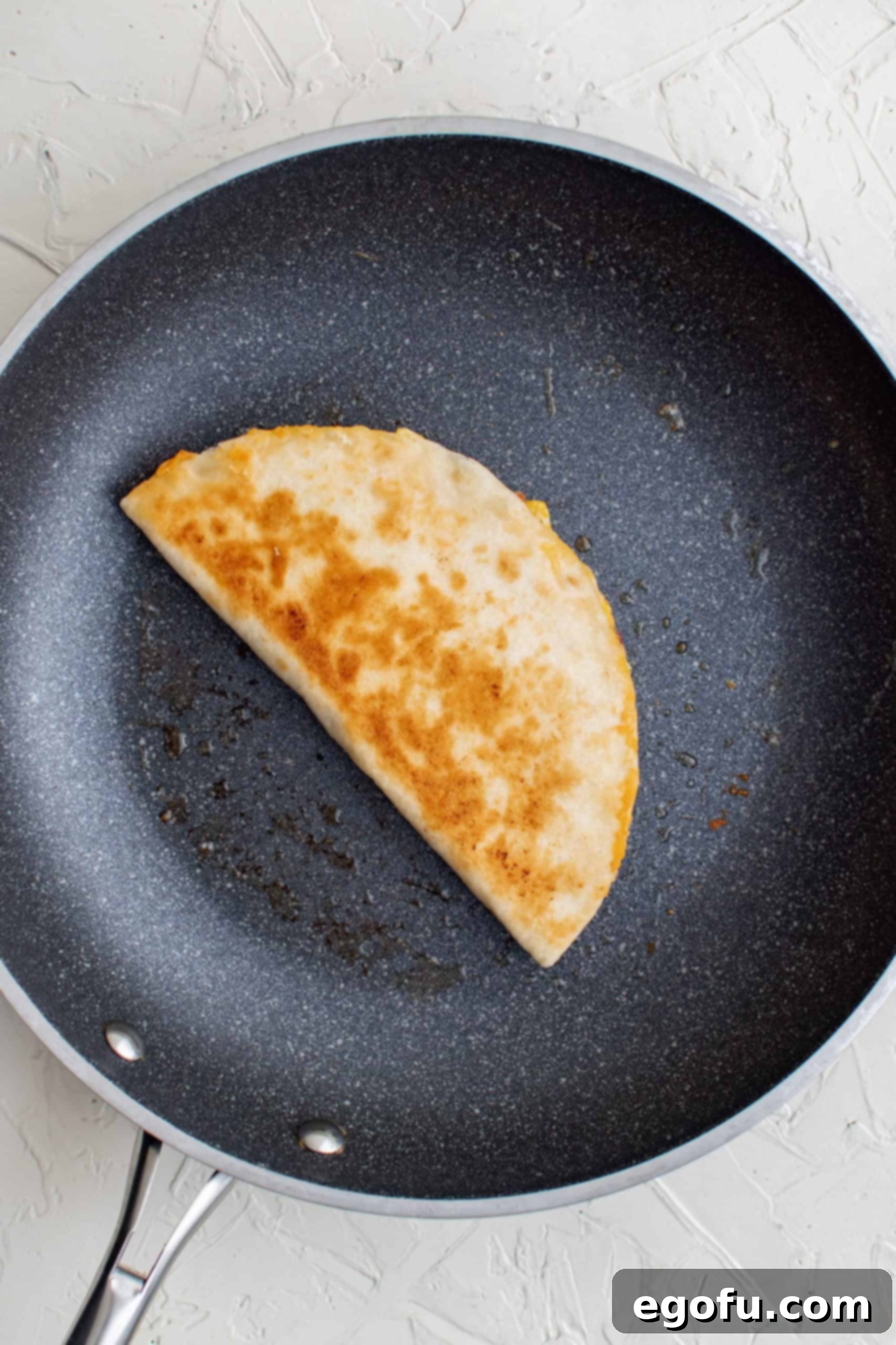 Browned finished quesadilla in pan.
