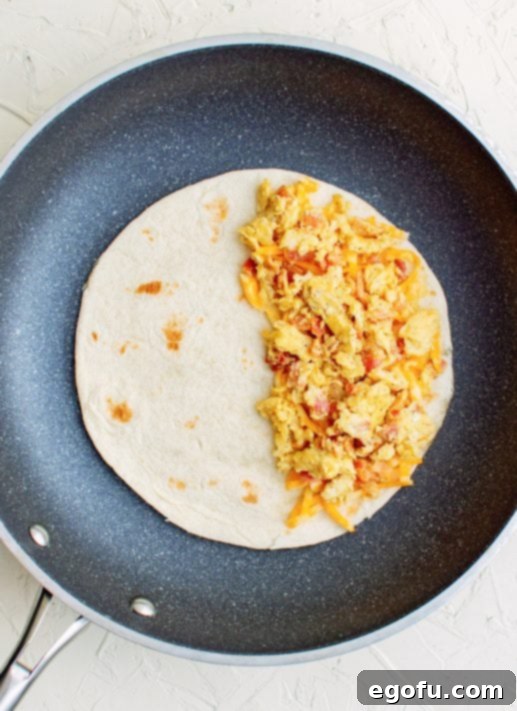 Bacon and egg mixture placed on top of cheese