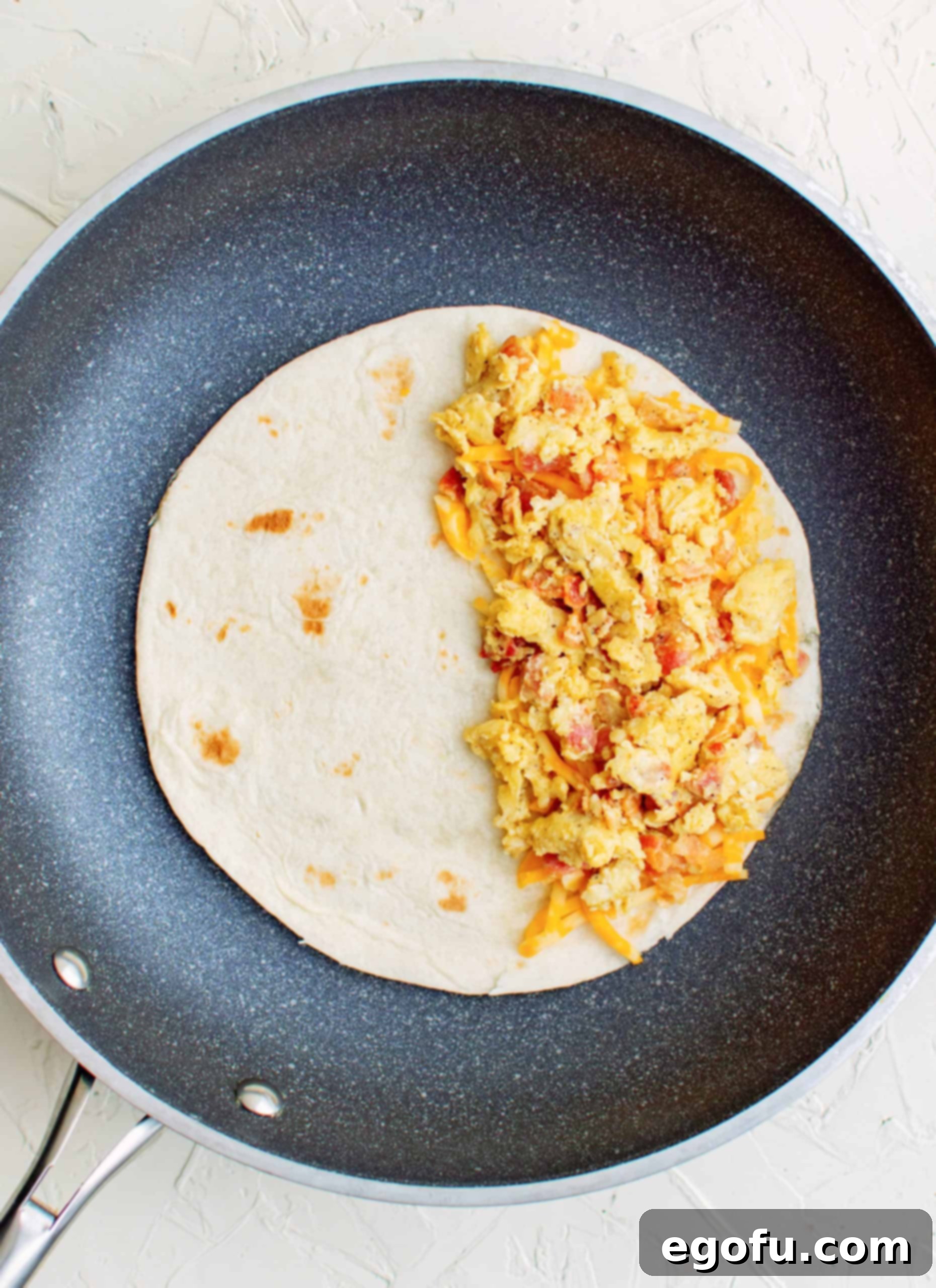 Bacon and egg mixture placed on top of cheese.