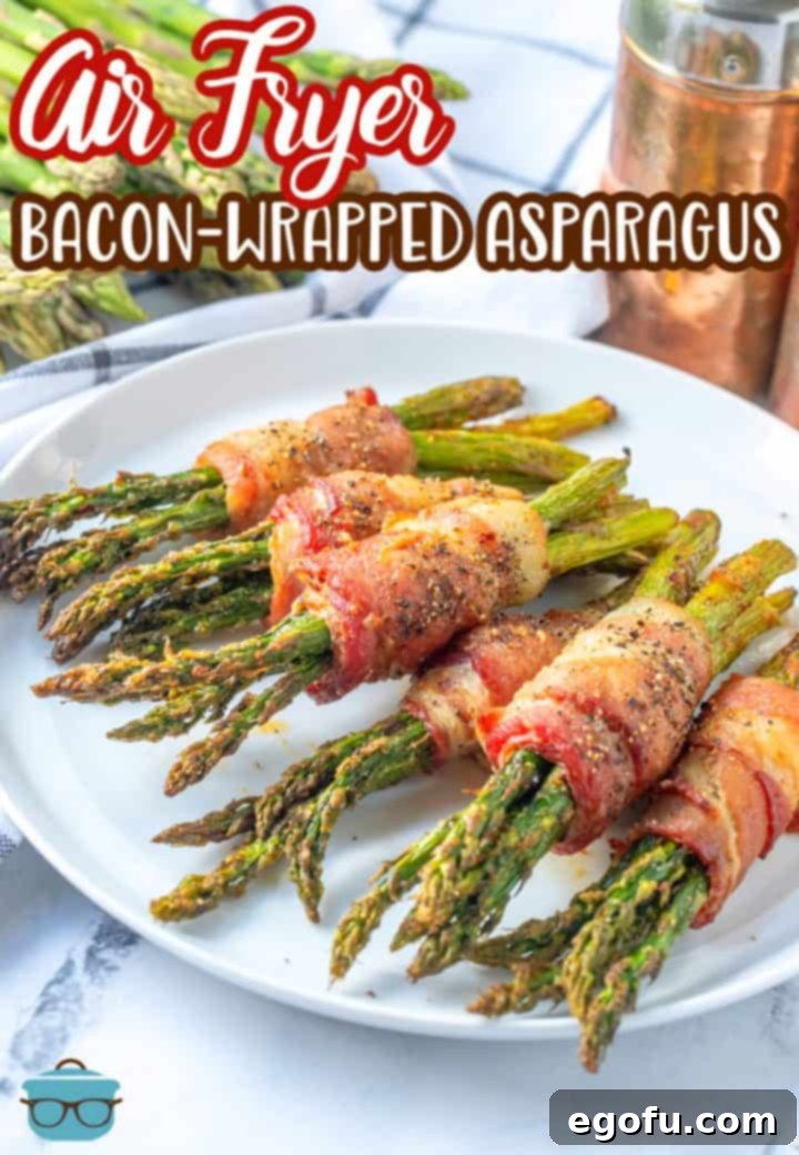 Crispy Air Fryer Bacon Asparagus Bundles 3 Bundles of air fryer bacon wrapped asparagus laid out on a round white plate.