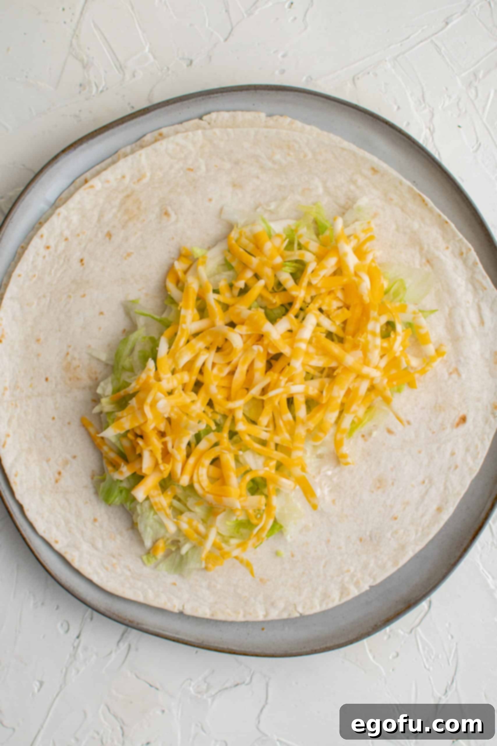 Cheese on top of shredded lettuce.