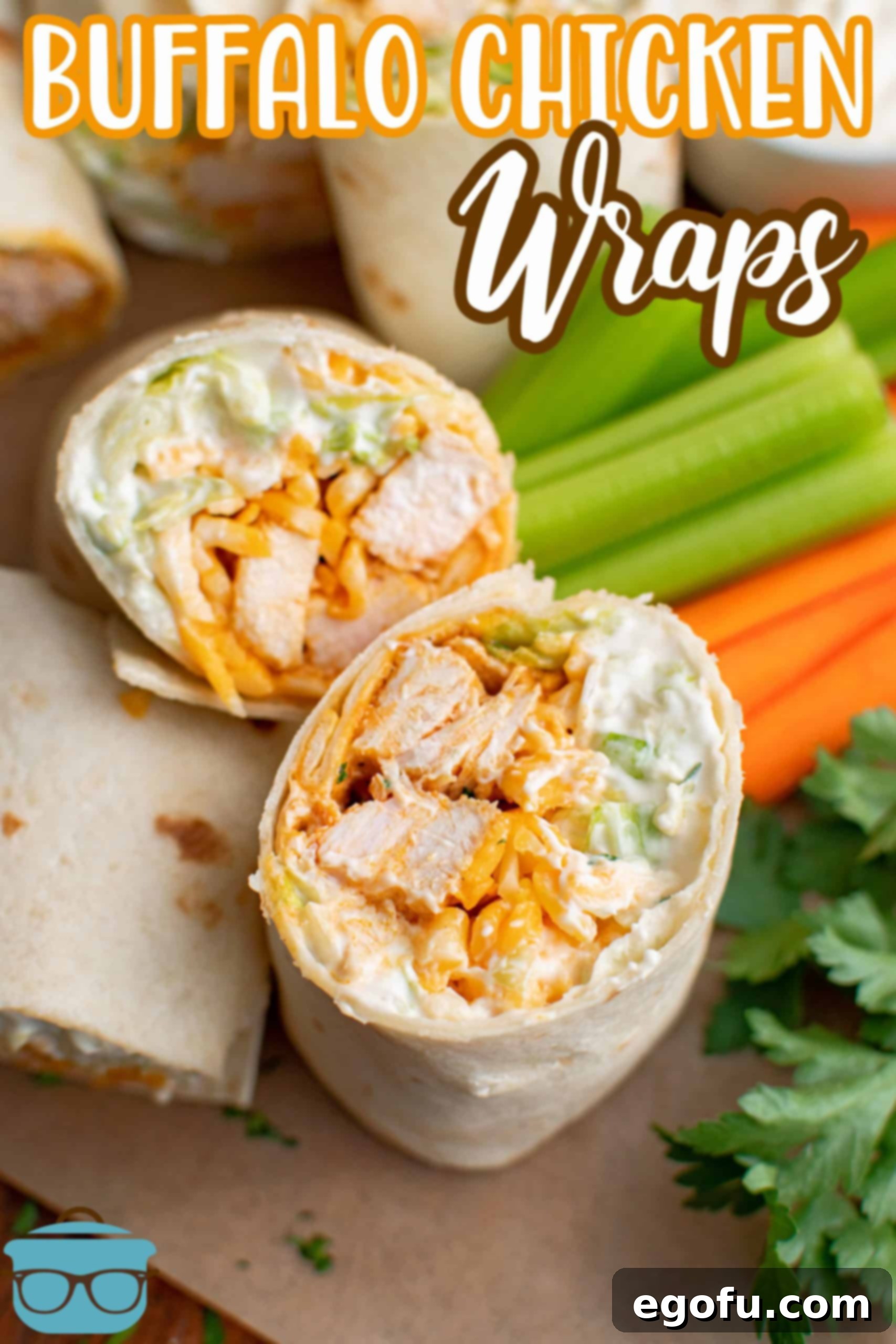 One cut open Buffalo Chicken wrap next to carrots and celery.