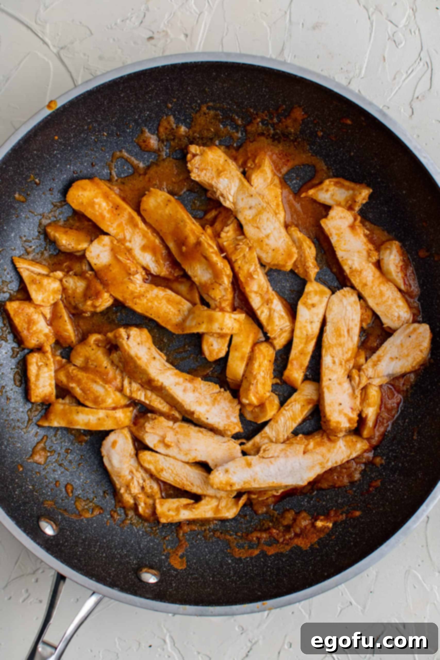 Sliced up chicken in pan.