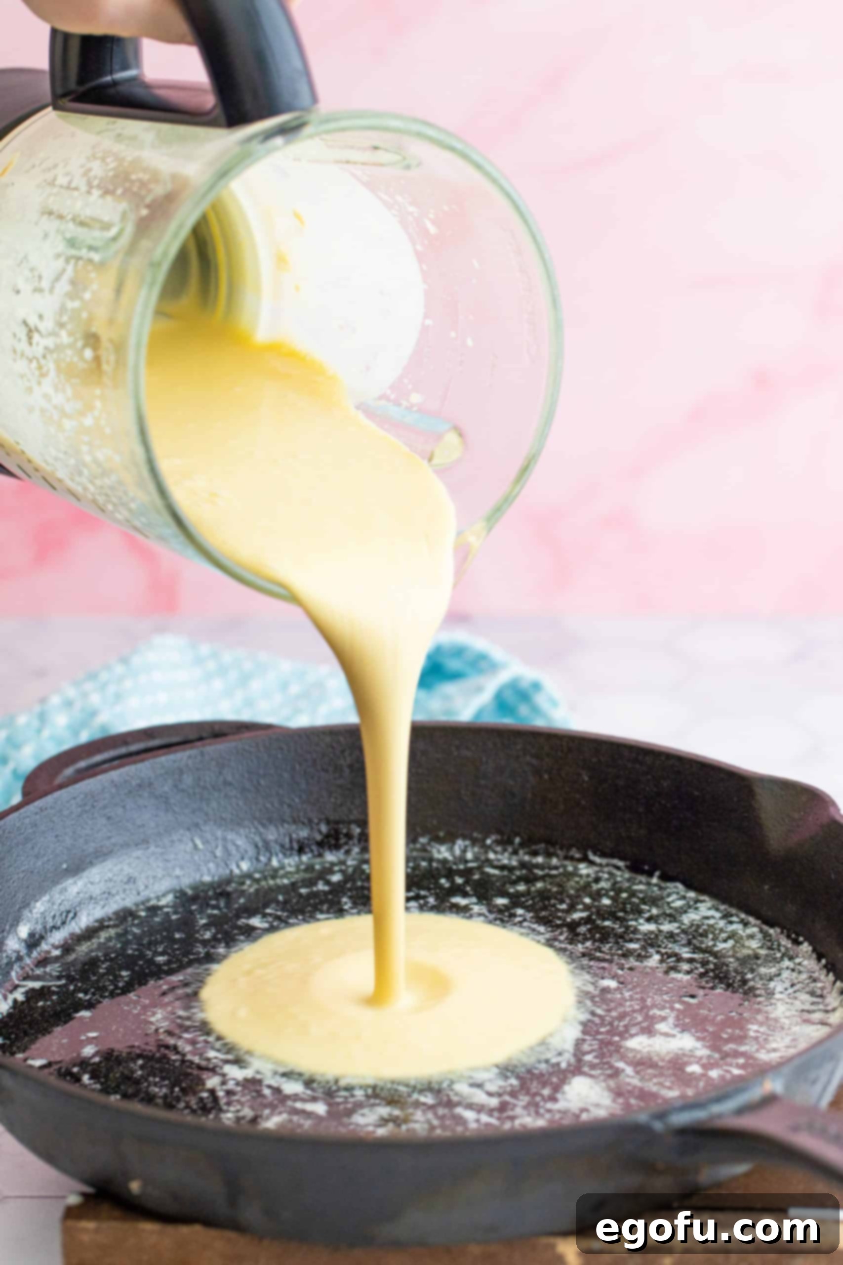Oven Baked Cloud Pancake 6 Batter being poured into a cast iron skillet.