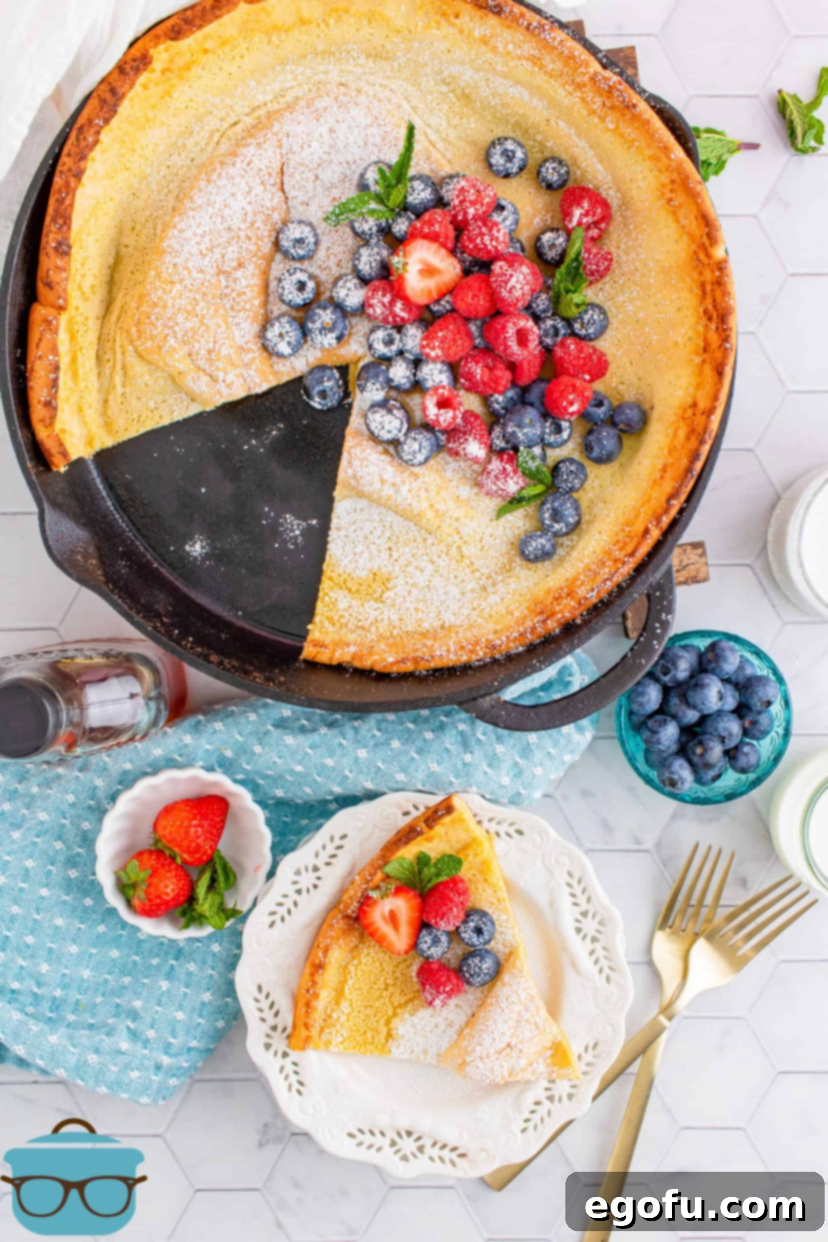 Oven Baked Cloud Pancake 8 Overhead of a Dutch Baby Pancake with slices taken out of pan on white plate.