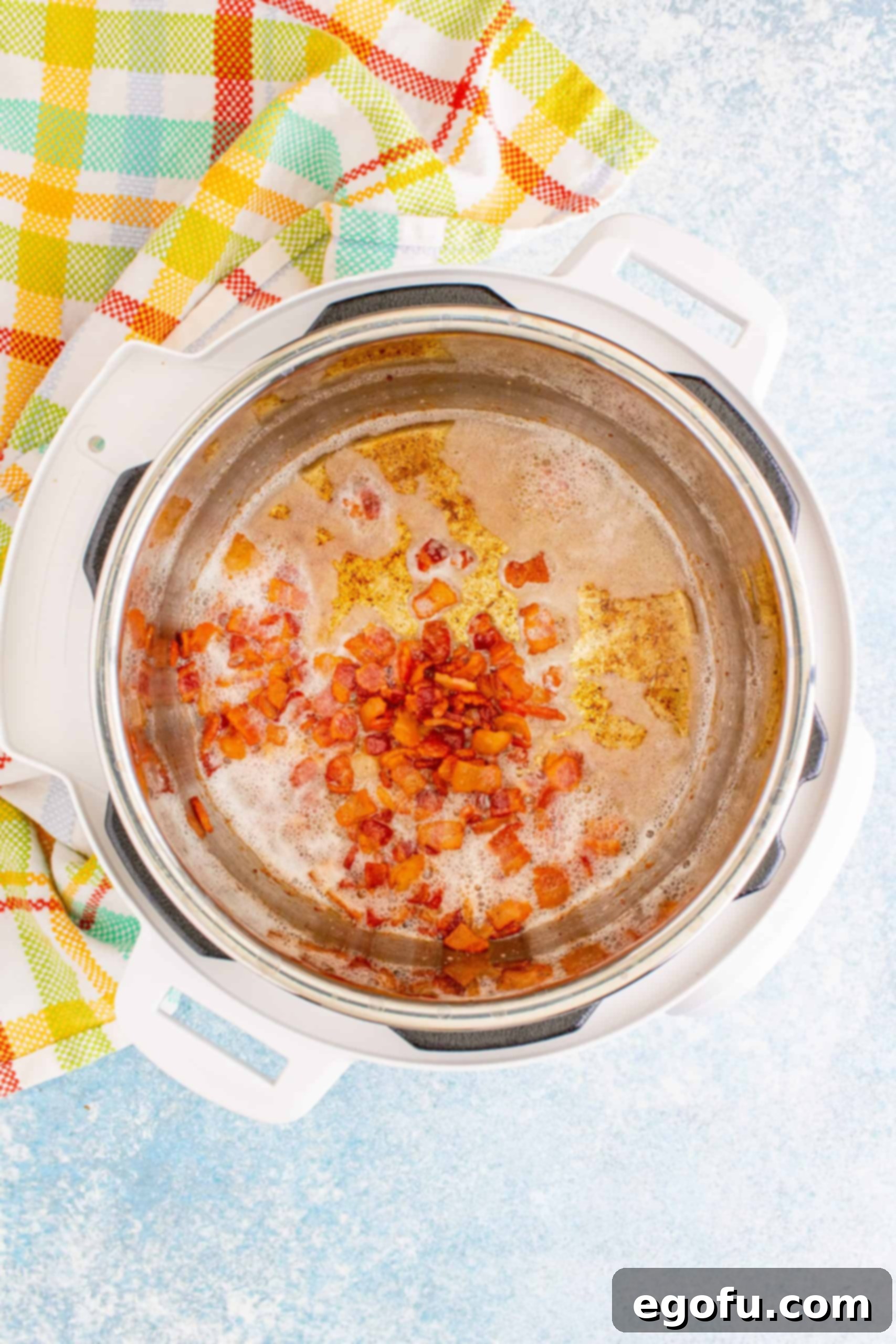 Crispy bacon pieces frying in the Instant Pot, ready to be removed.