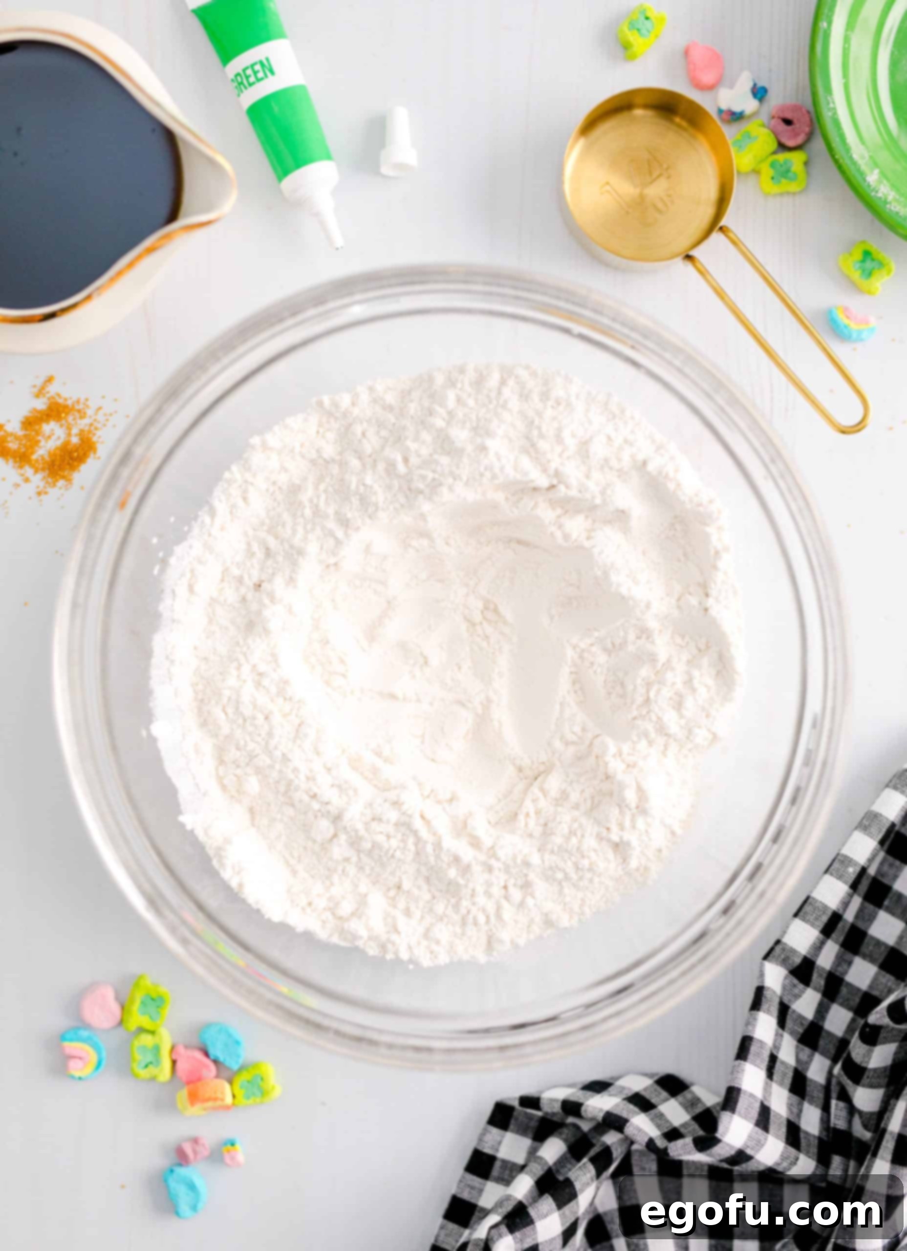 Whisked dry ingredients in a bowl with a noticeable well created in the center, perfectly prepared to receive the wet ingredients for the pancake batter.