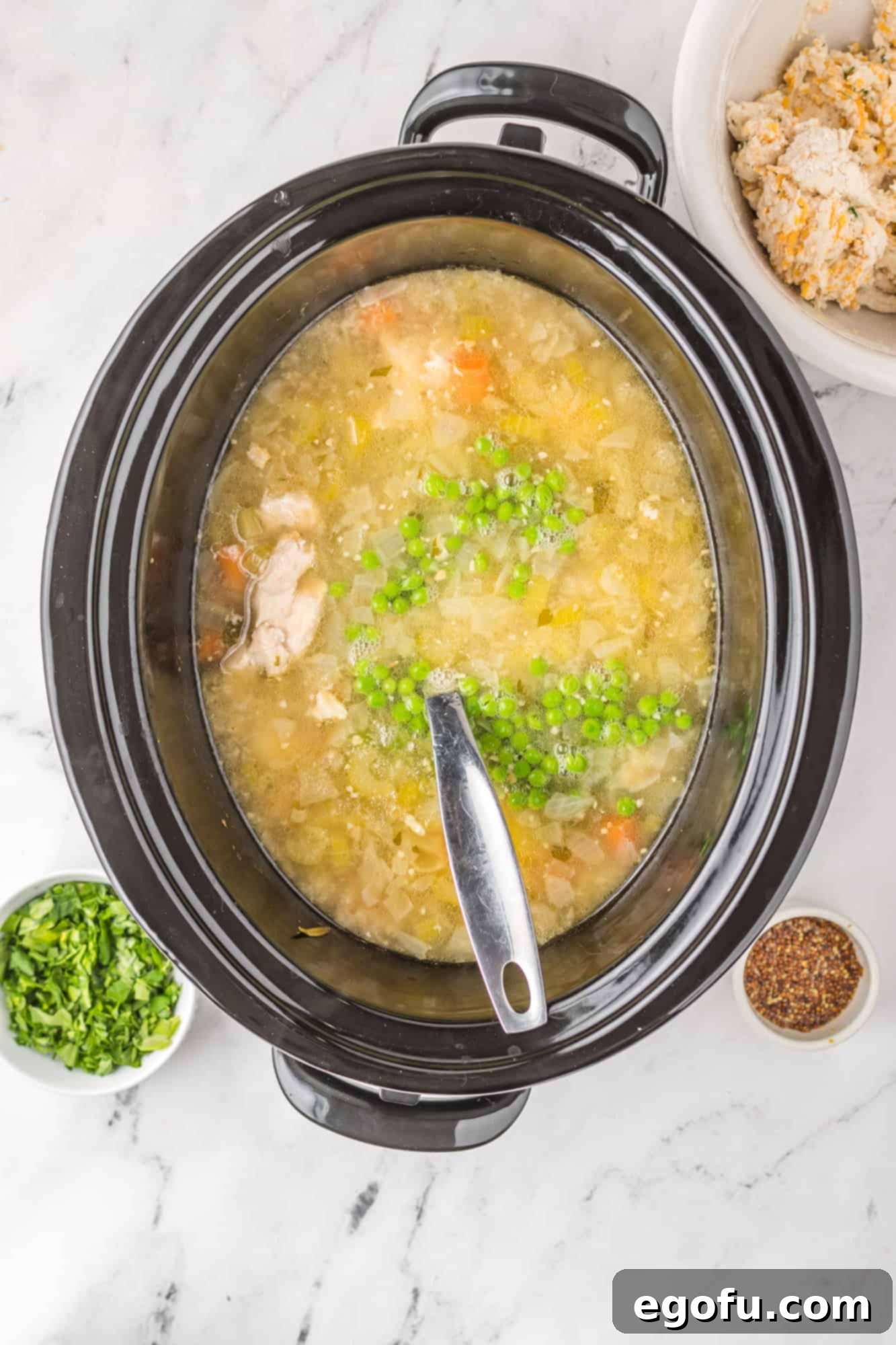 Peas, parsley and cream added to chicken and soup mixture.