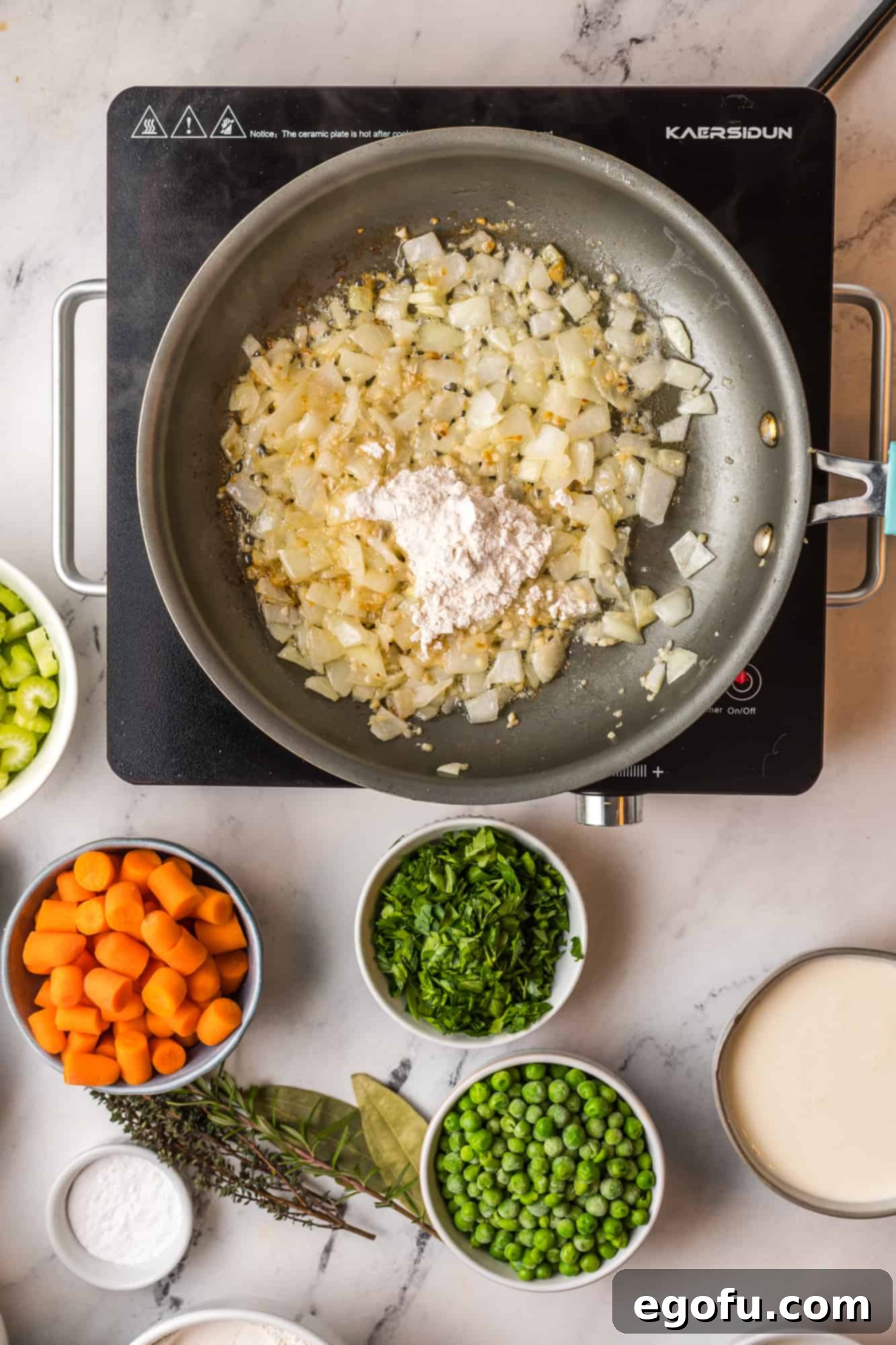 Flour added to onions in pan.