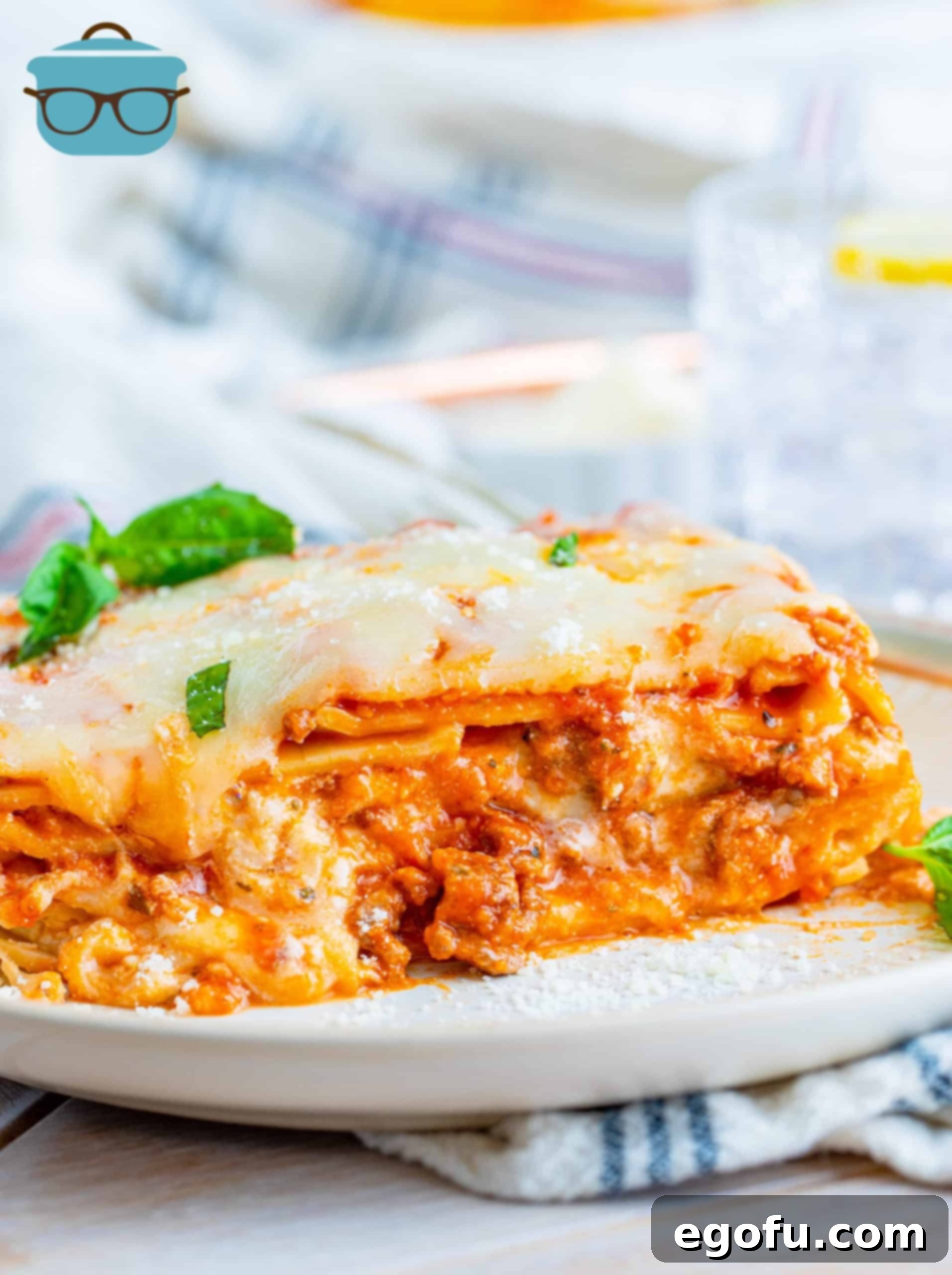 Hearty Homemade Lasagna Bake 2 Homemade Baked Lasagna Recipe slice on white plate.