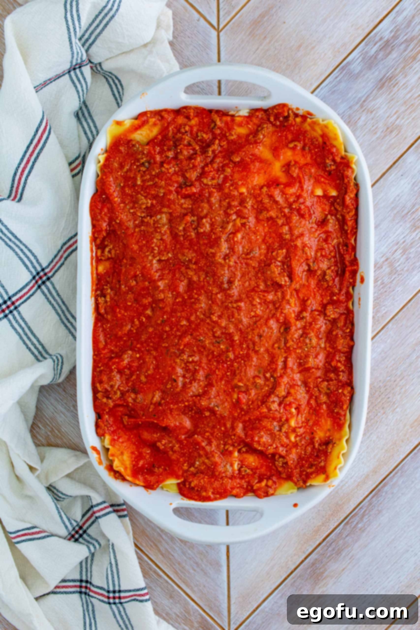 Hearty Homemade Lasagna Bake 8 Meat sauce spread evenly on top of lasagna noodles.