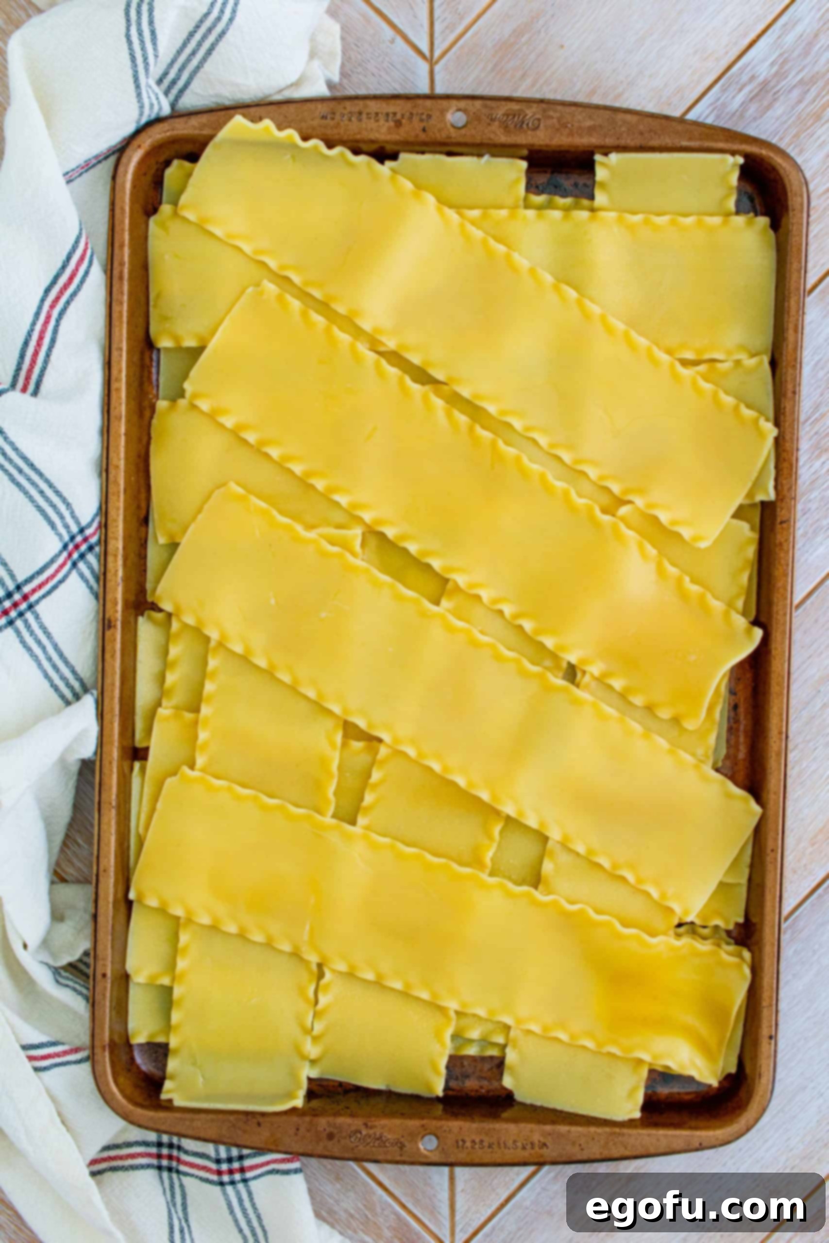 Hearty Homemade Lasagna Bake 7 Cooked lasagna noodles in a criss cross pattern on baking sheet.