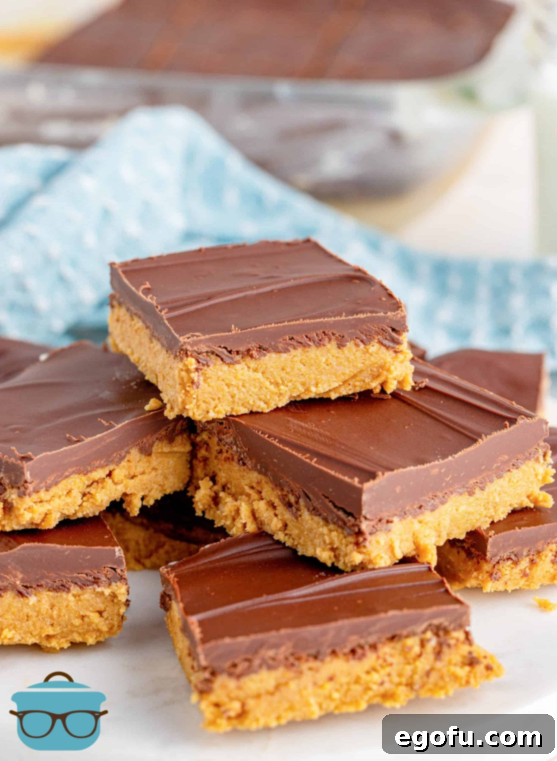 Grandma's No-Bake Peanut Butter Dream Bars 13 Beautifully layered Grandma's Peanut Butter Bars arranged on a plate, cut into perfect squares and ready to eat.
