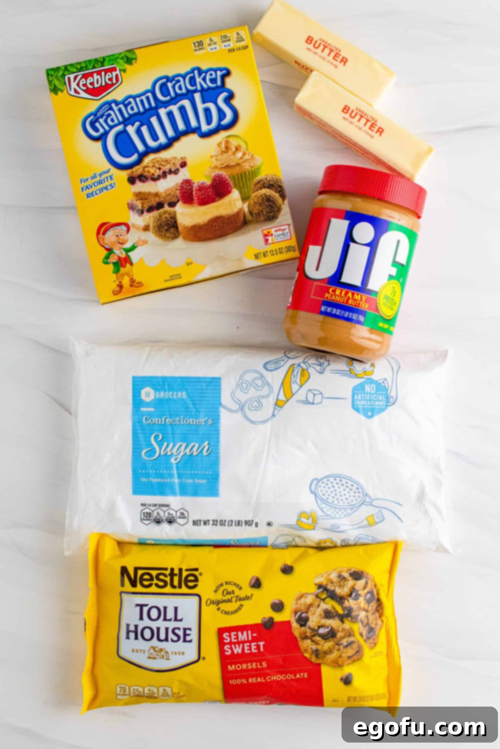 Grandma's No-Bake Peanut Butter Dream Bars 4 Ingredients needed to make Grandma's Peanut Butter Bars: butter, powdered sugar, graham cracker crumbs, peanut butter, and chocolate chips, neatly arranged.