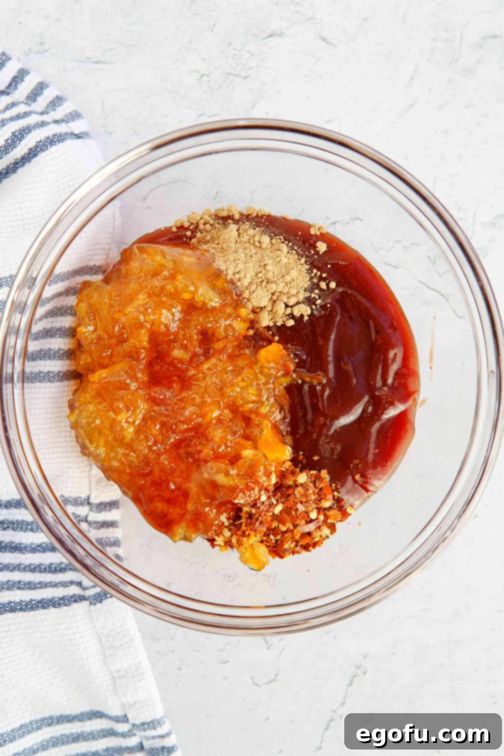 Skillet Orange Chicken Crumble 5 A close-up view of the vibrant orange sauce for Ground Orange Chicken, perfectly mixed in a bowl and ready to be added to the cooked chicken.