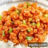 Skillet Orange Chicken Crumble 9 Close up of finished Orange Chicken on plate with rice square image