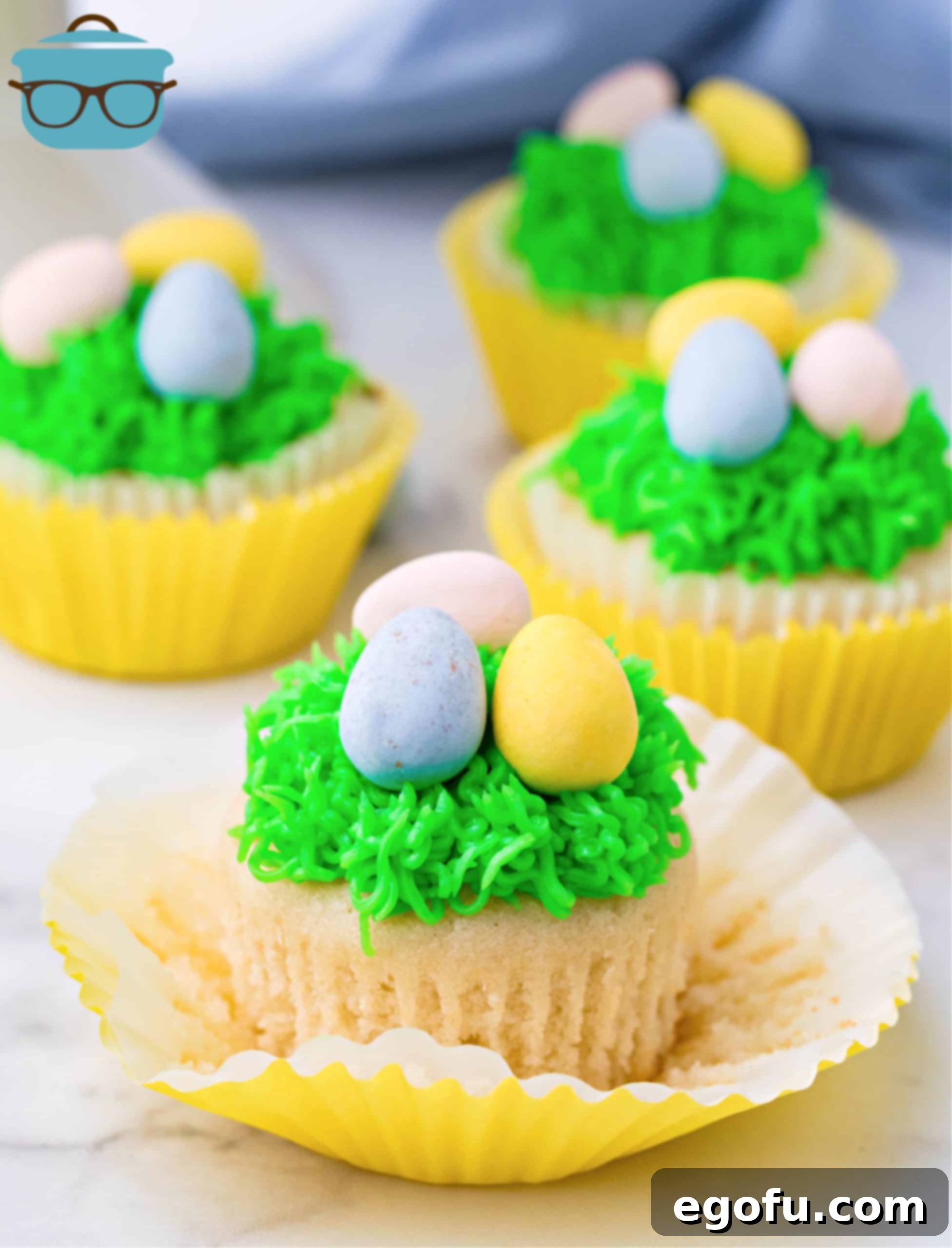 A peeled-back cupcake liner reveals the perfectly baked vanilla cupcake, ready for frosting and decoration.