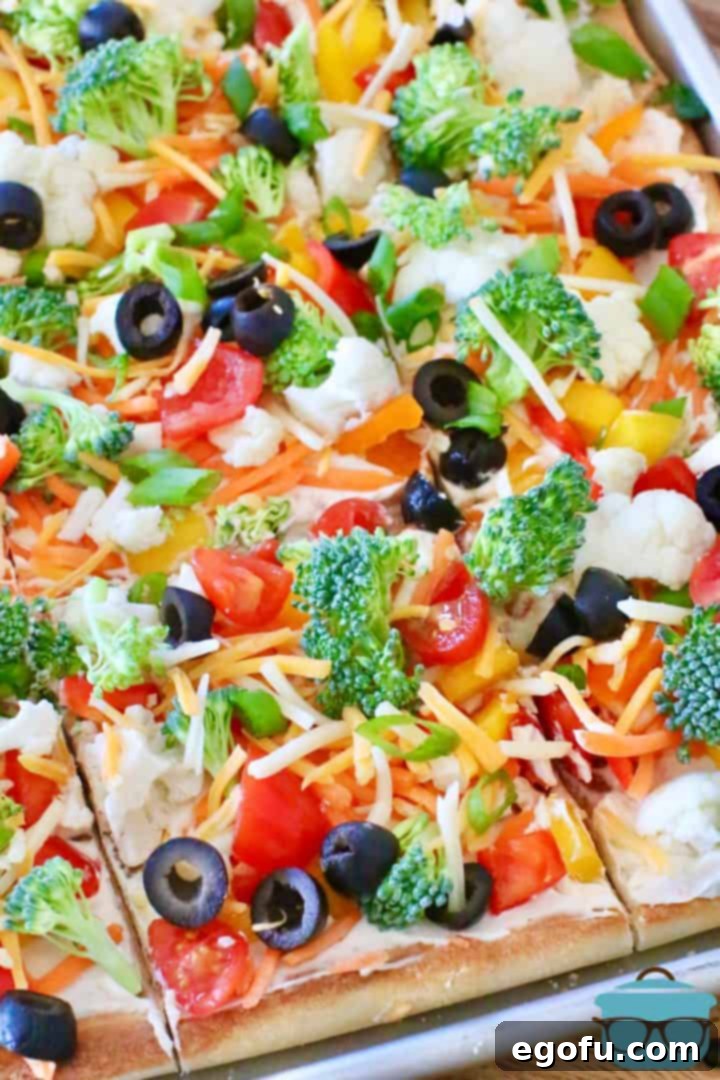 Veggie Cream Cheese Pizza shown in slices on a baking sheet