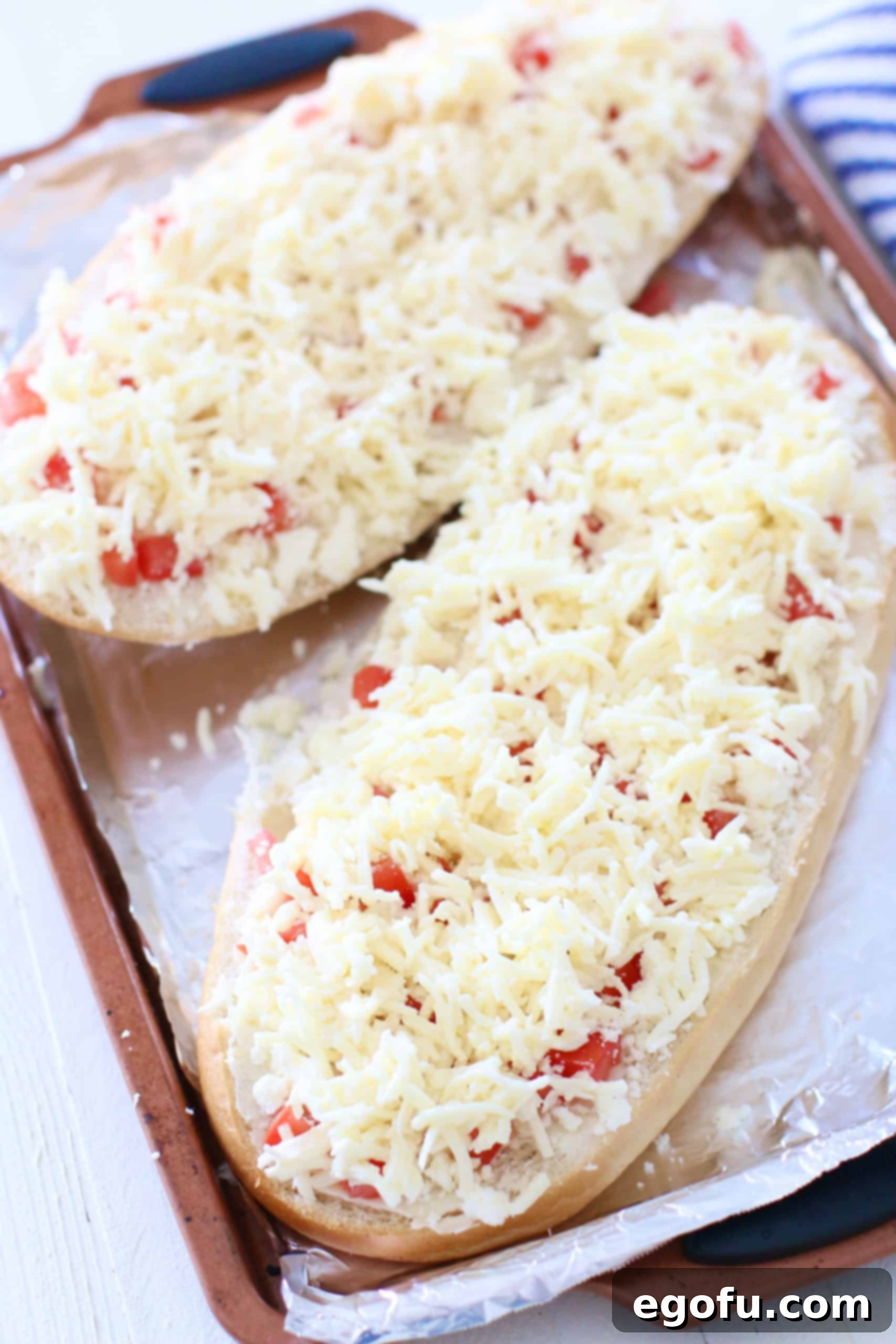 shredded mozzarella cheese on bread.