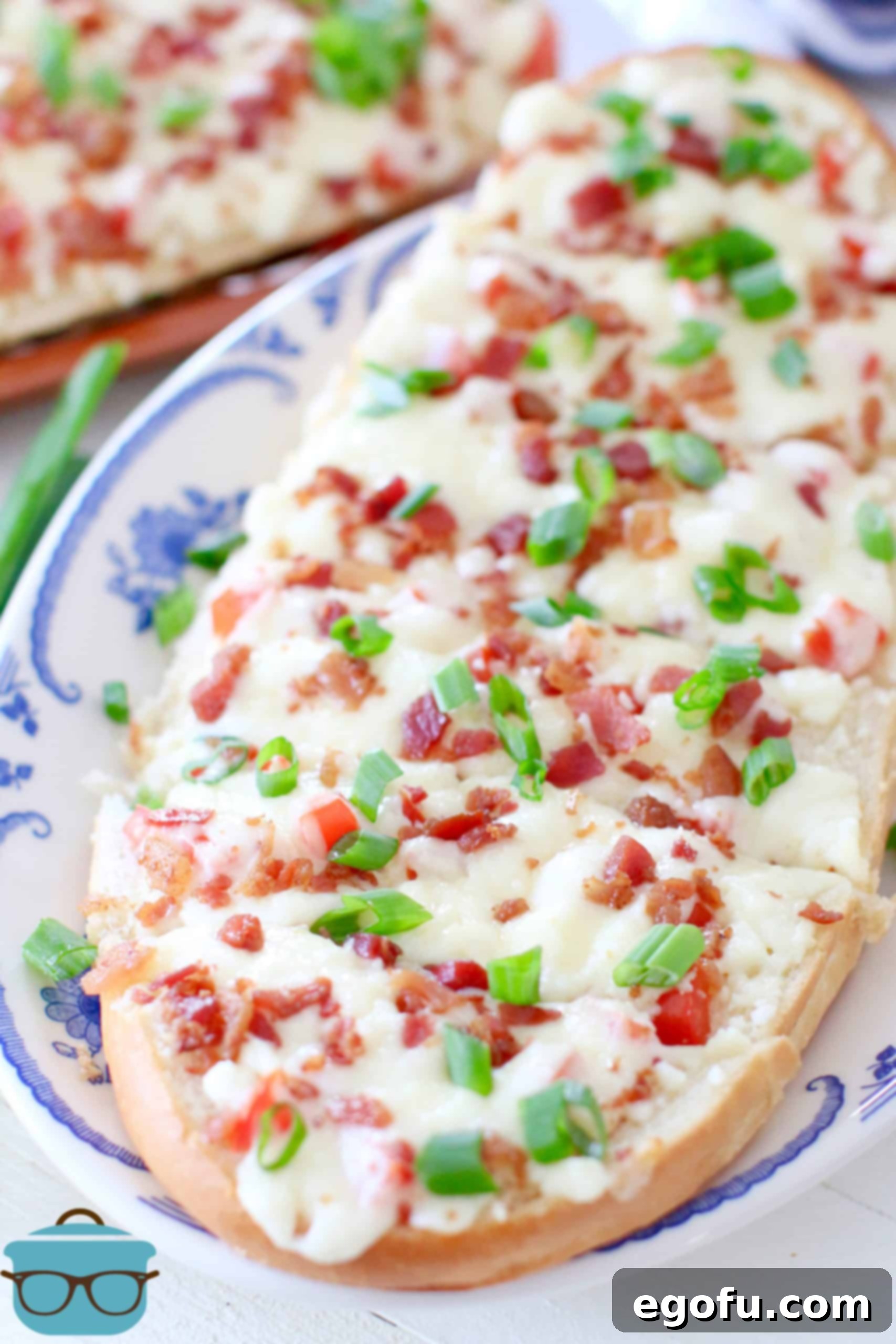 sliced cheese bread shown on a blue and white platter.