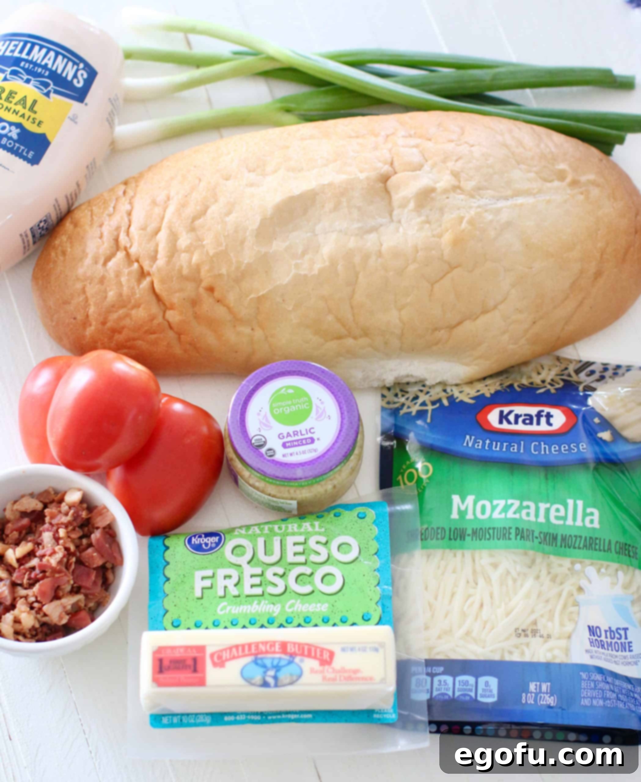 Florida Beach Bread ingredients: Italian Bread. salted butter, minced garlic, Roma tomatoes, queso fresco, shredded mozzarella cheese, mayonnaise, bacon pieces, green onions.