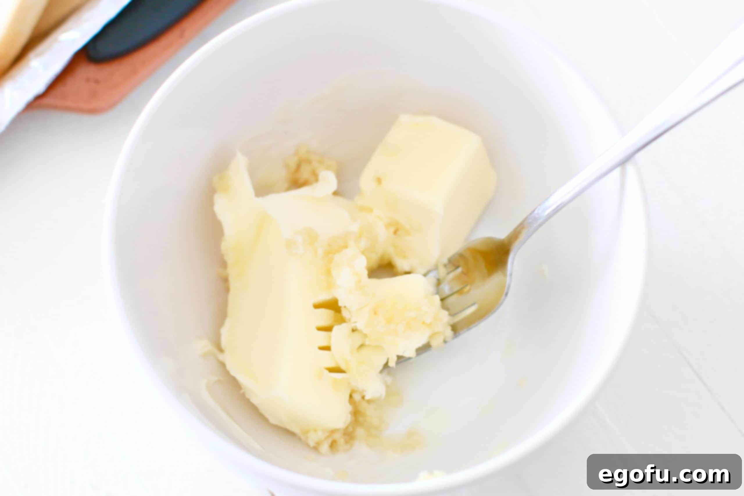 softened butter and minced garlic in a bowl.