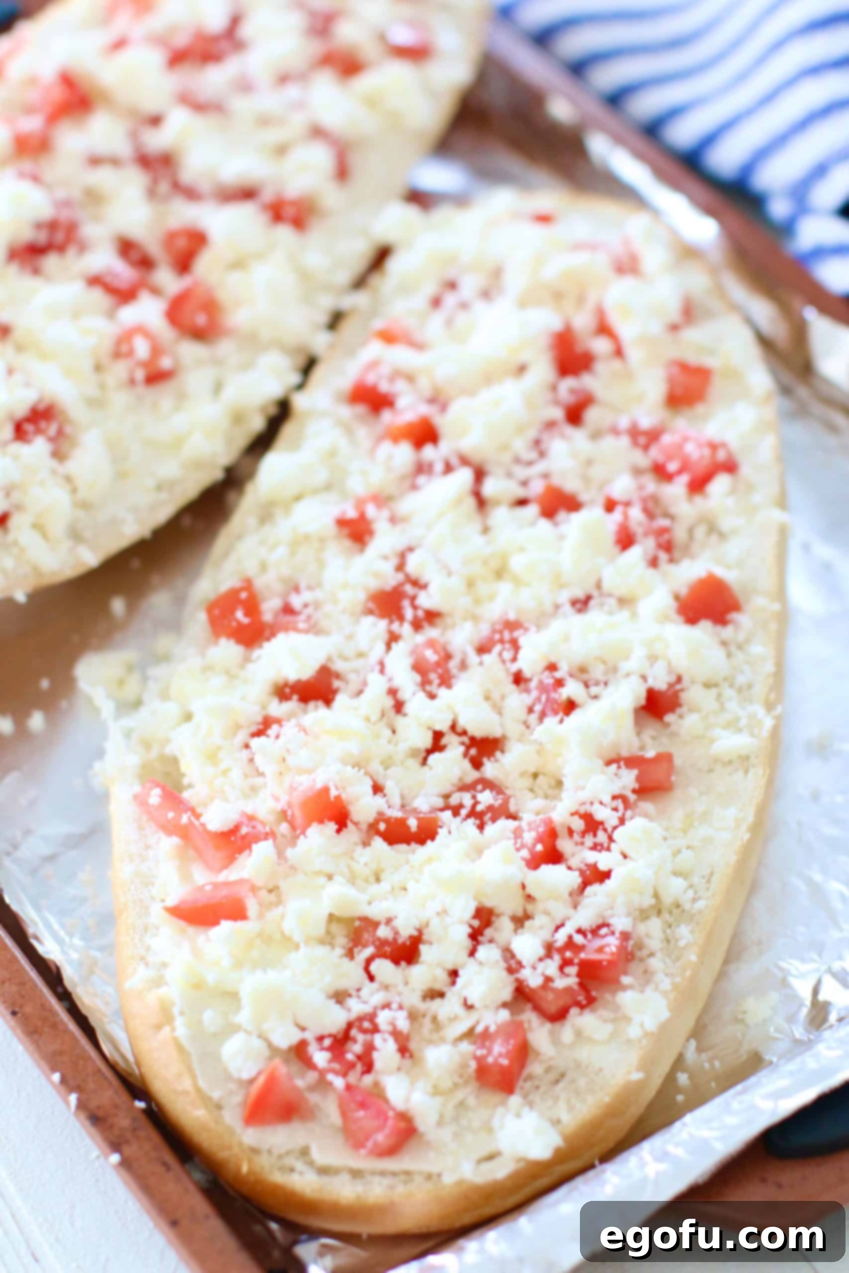 crumbled queso fresco sprinkled evenly on diced tomato layer.