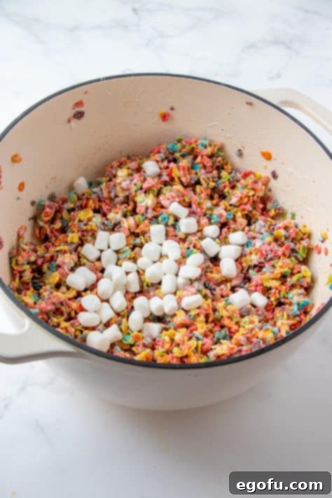 Whole marshmallows added to fruity pebble mixture.