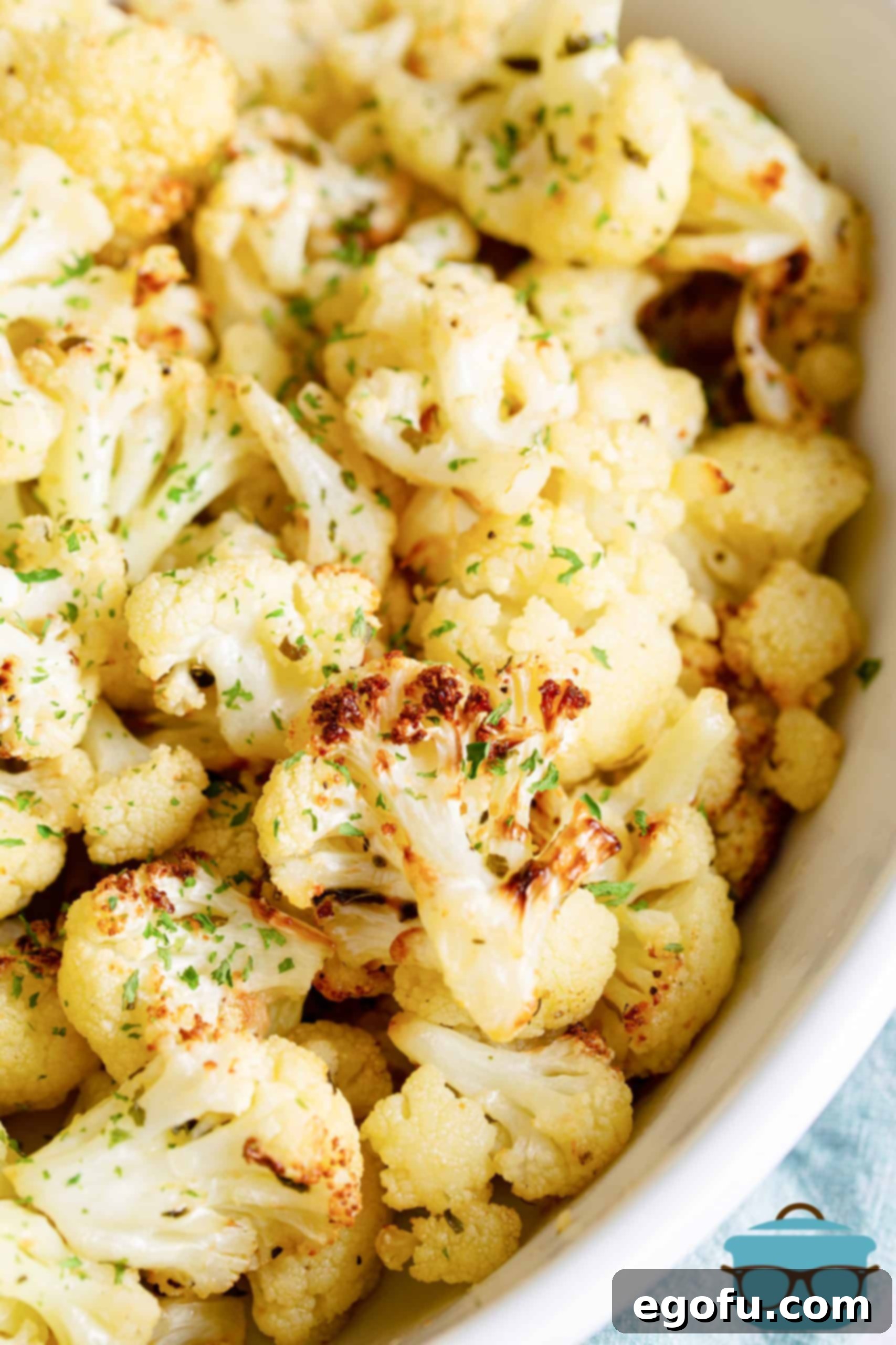 Overhead of Air Fryer Roasted Cauliflower in white bowl, perfectly golden and seasoned.