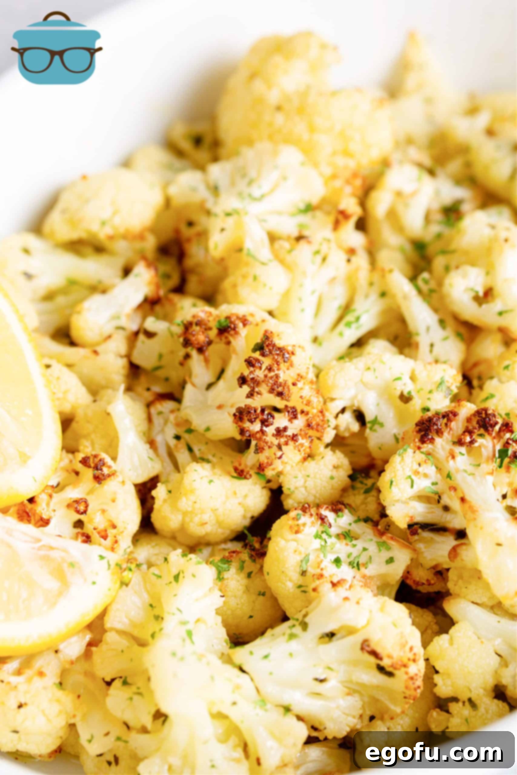 Finished Air Fryer Roasted Cauliflower in a white serving bowl, showing its crispy, golden-brown exterior and steaming hot interior.