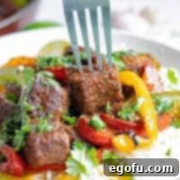 Square image of close up of fork going into a piece of steak in Fajita Bowl