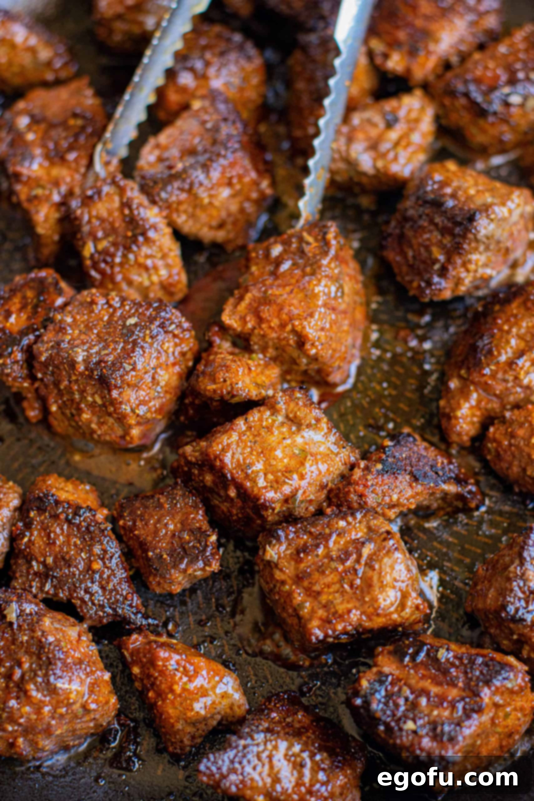 Steak being cooked in pan.