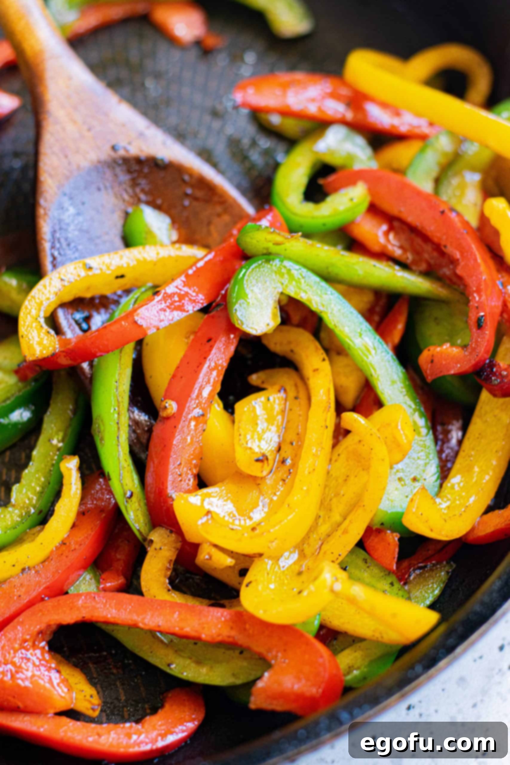 Peppers being cooked in pan.