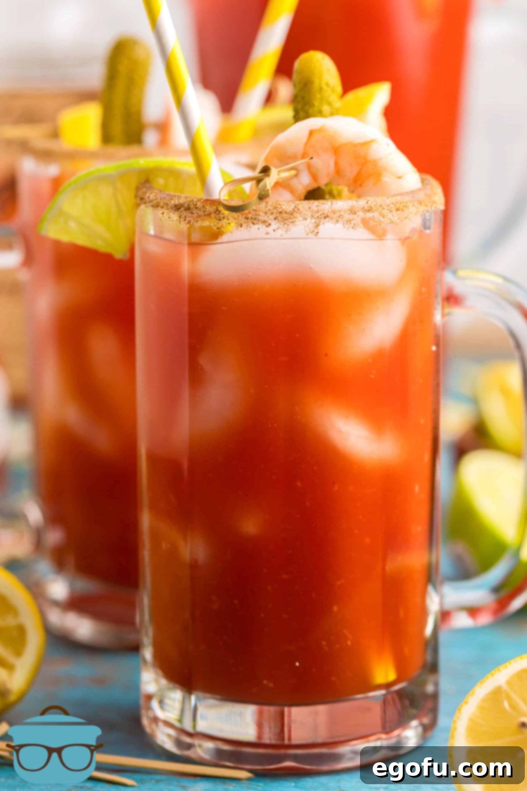 Signature Bloody Mary Blend 2 Bloody Mary Mix in tall glass with alcohol and garnishes.
