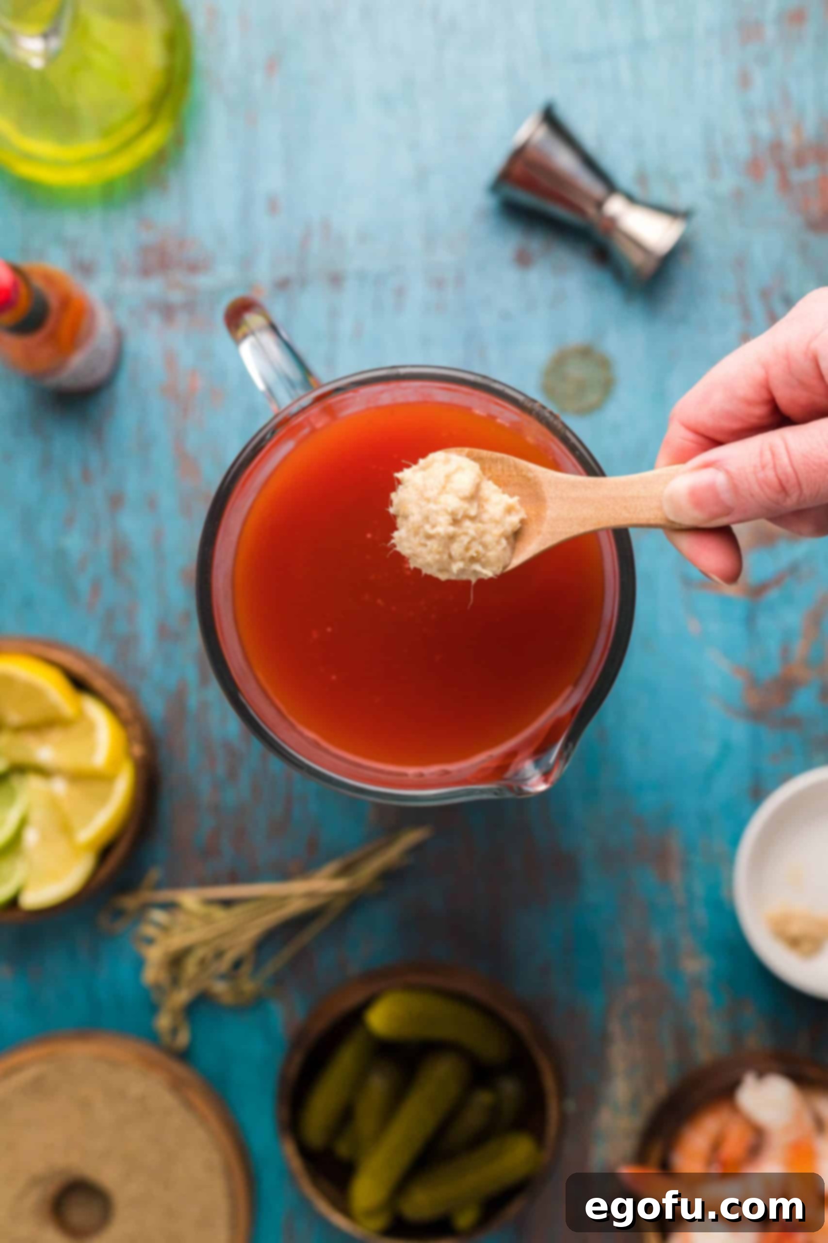 Signature Bloody Mary Blend 6 Horseradish being added to pitcher.