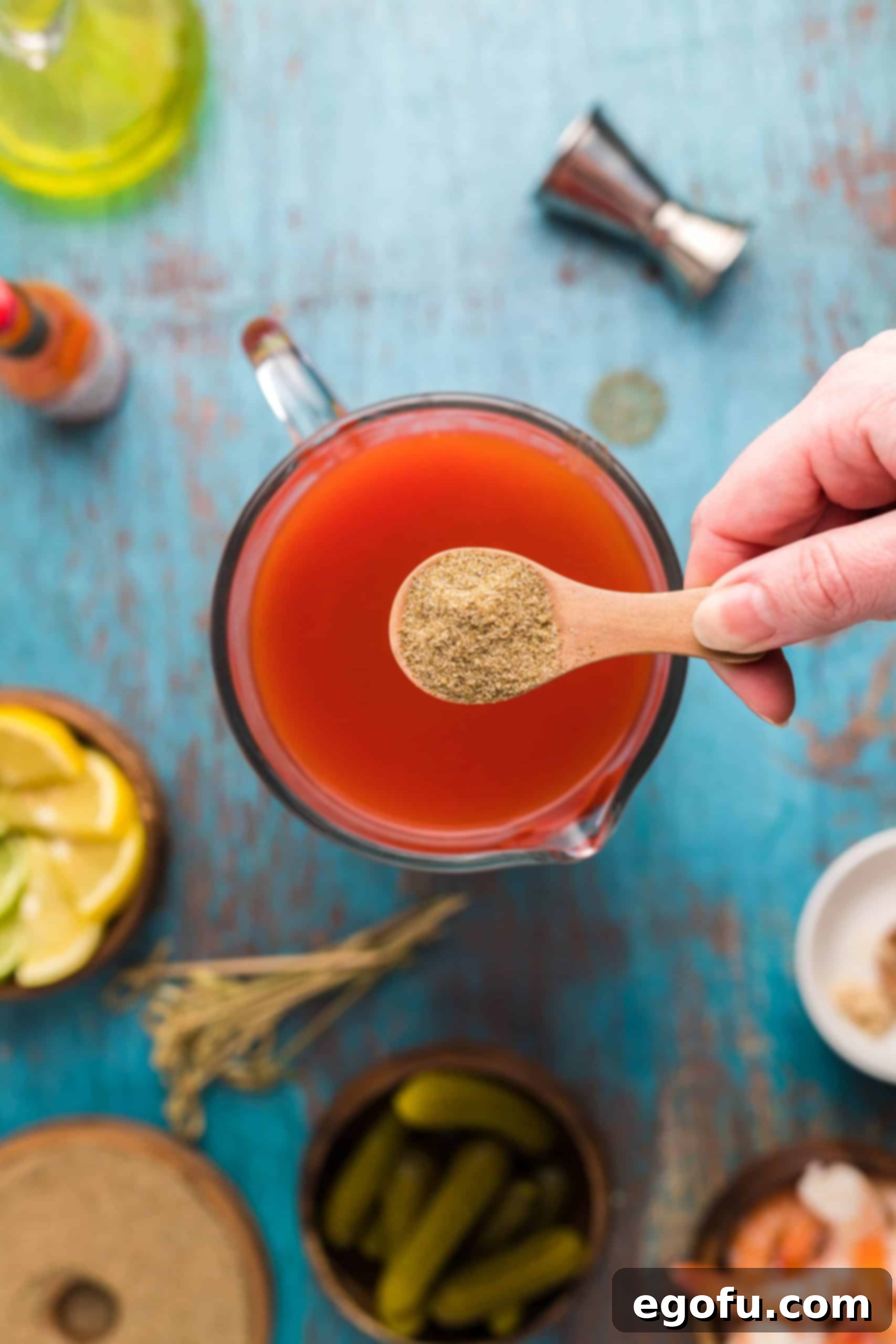 Signature Bloody Mary Blend 7 Celery salt being added to pitcher.