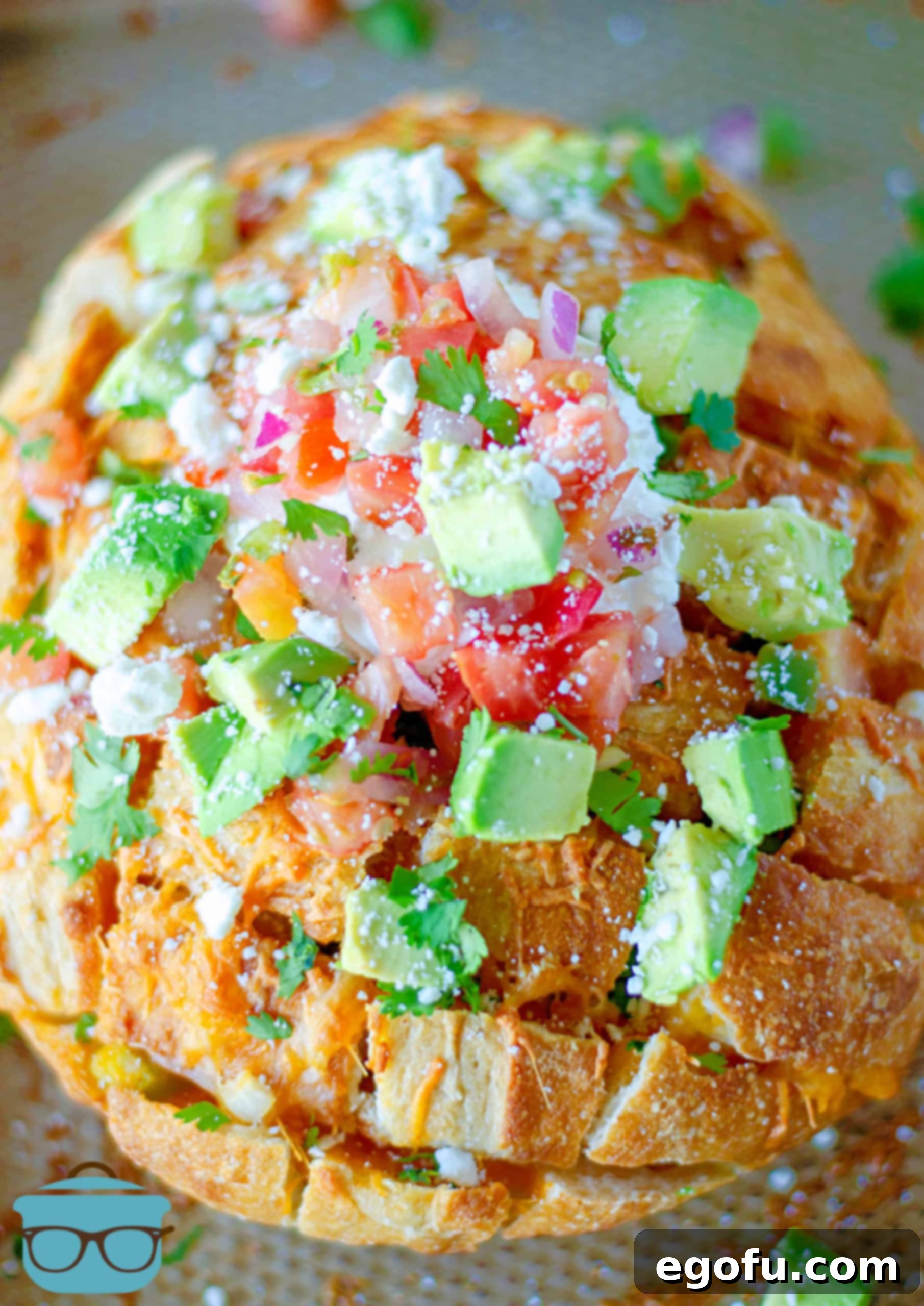 Finished Pull Apart Bread abundantly topped with an array of colorful taco toppings, beautifully arranged and ready to be served.