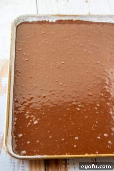 Cake batter poured into a flour baking pan