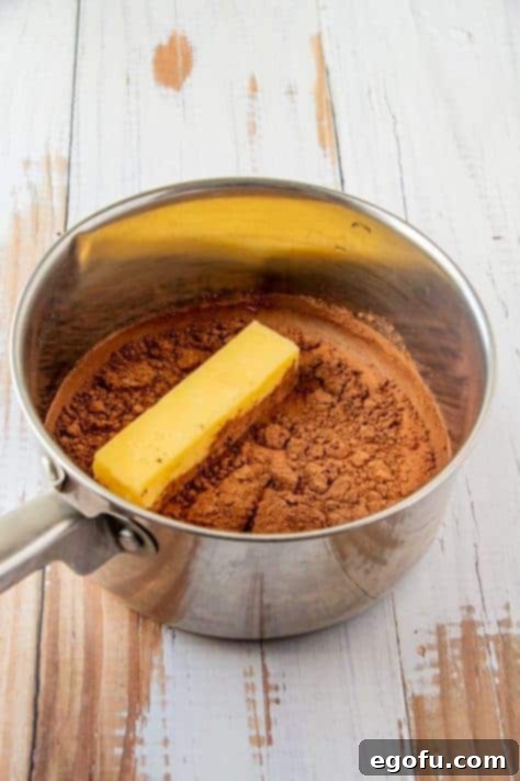 Margarine, milk and cocoa powder added to metal sauce pan