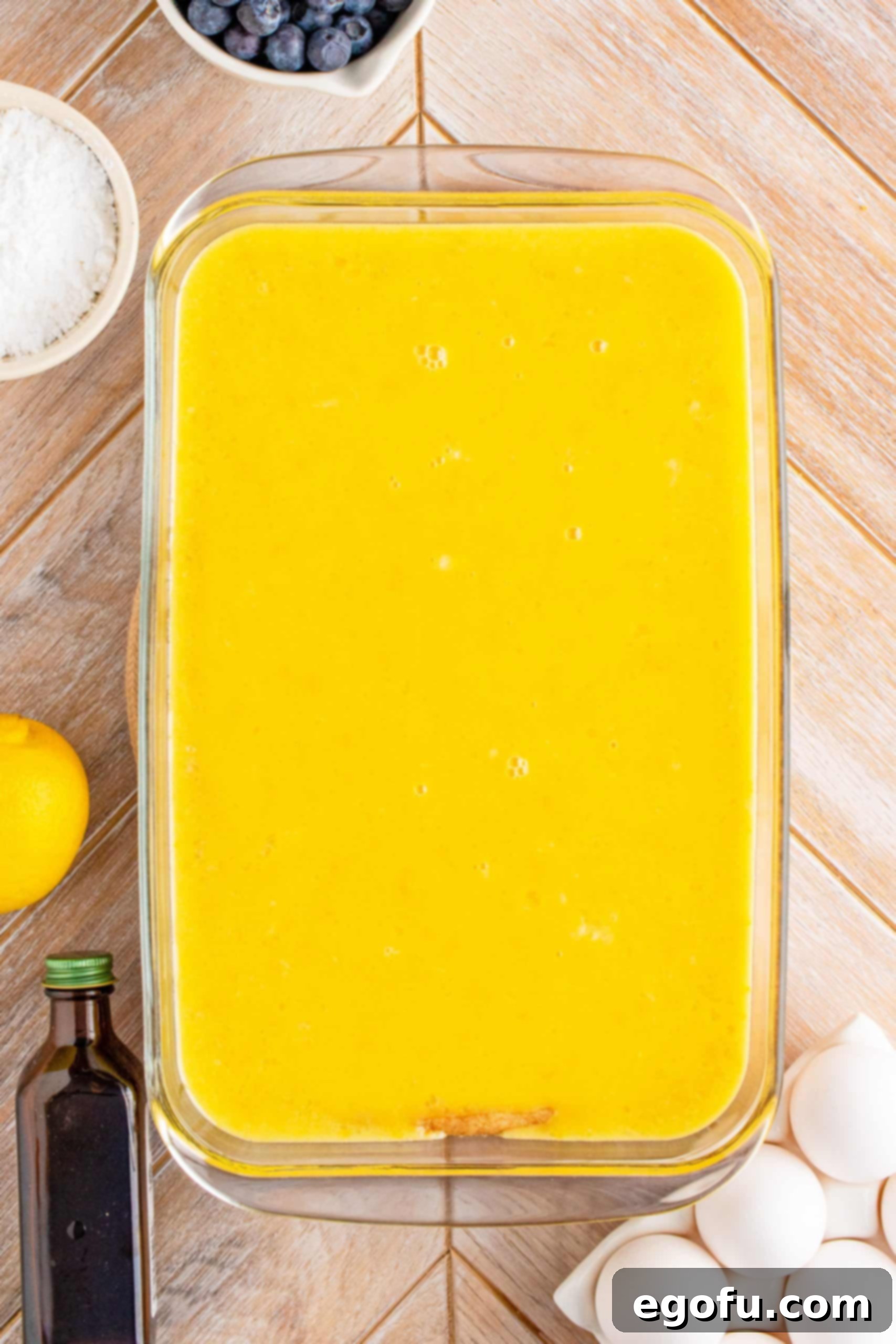 Lemon filling mixture poured over the baked crust in the baking pan.
