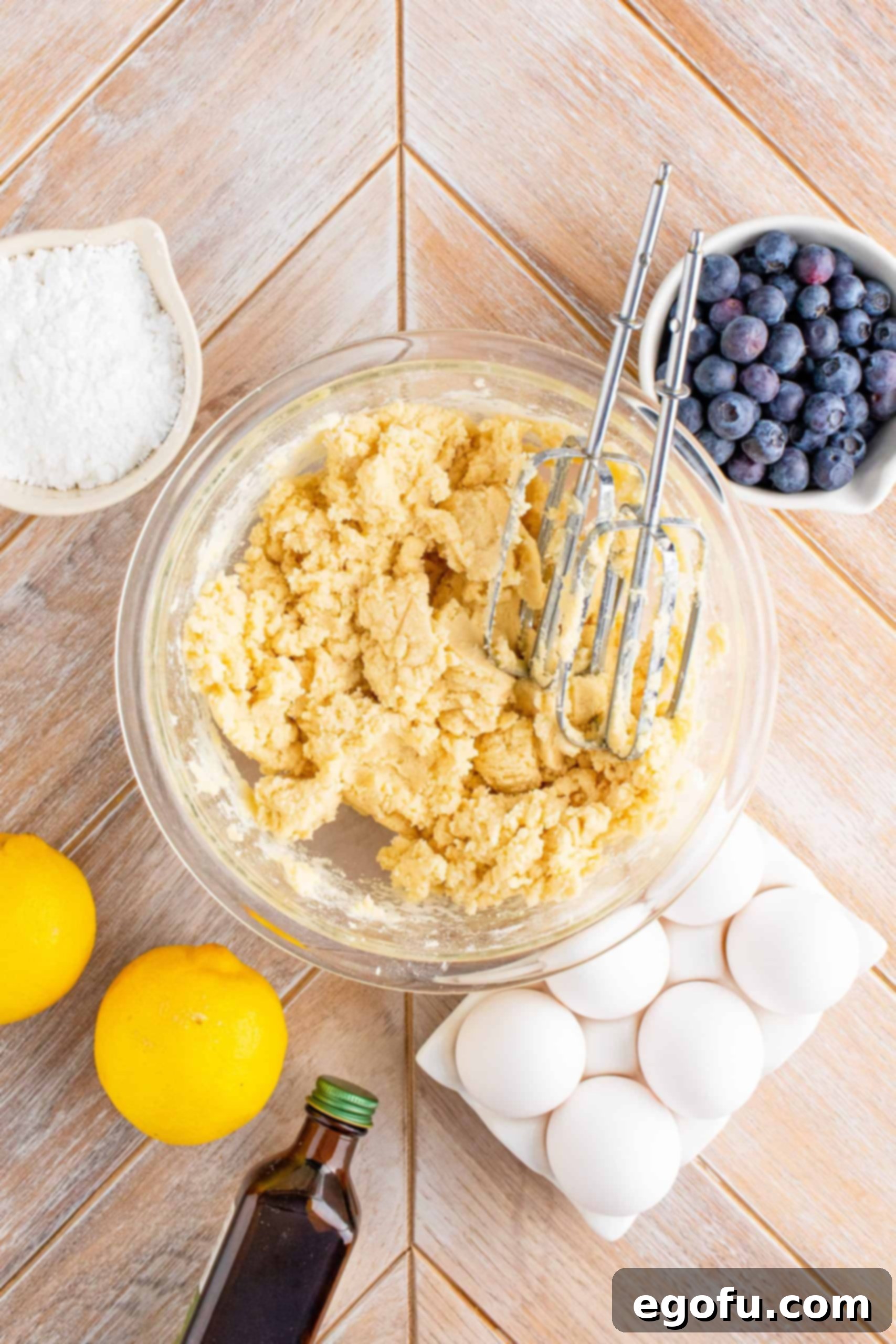 Crust mixture blended and crumbly in a clear mixing bowl.