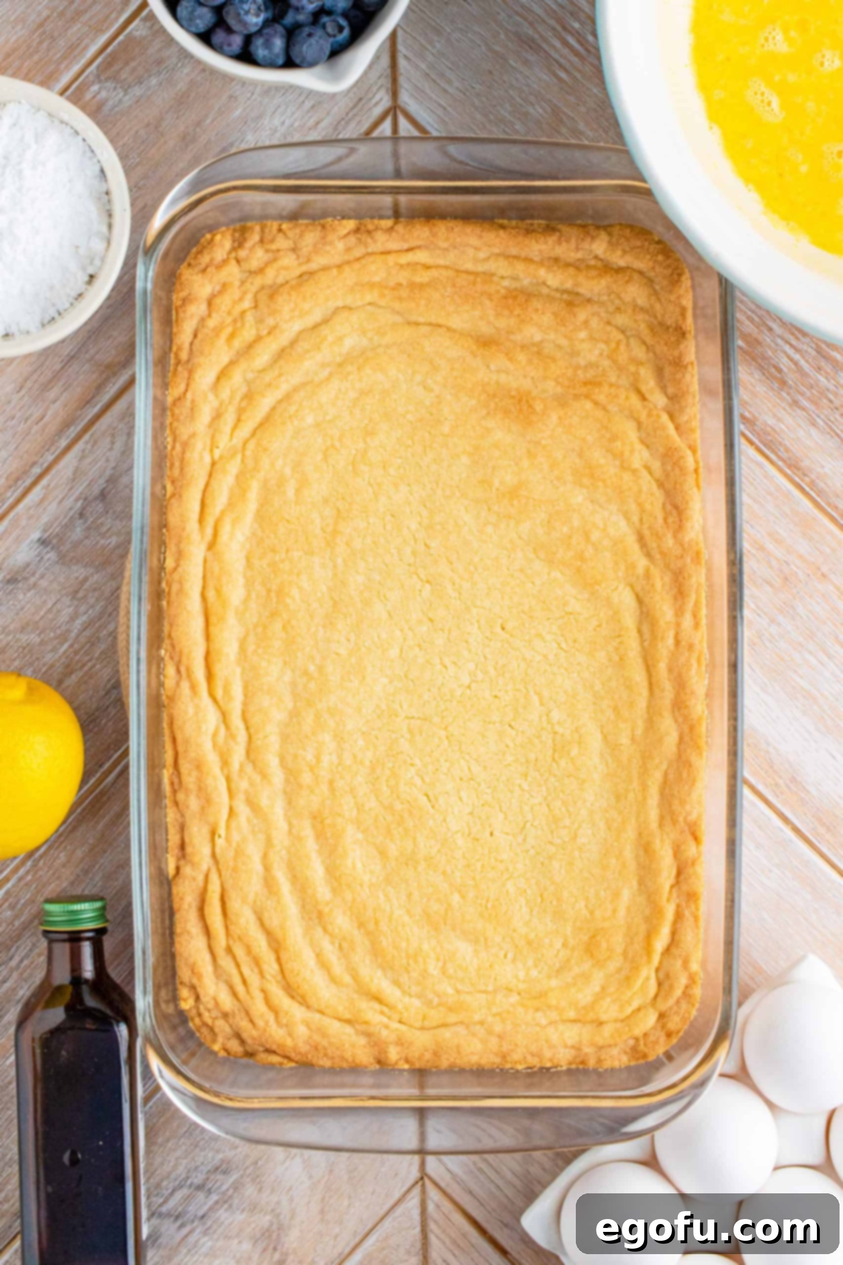 Cooked, lightly golden brown shortbread crust in the baking pan, just out of the oven.