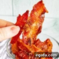 Square image close up of hand holding up a piece of Pig Candy