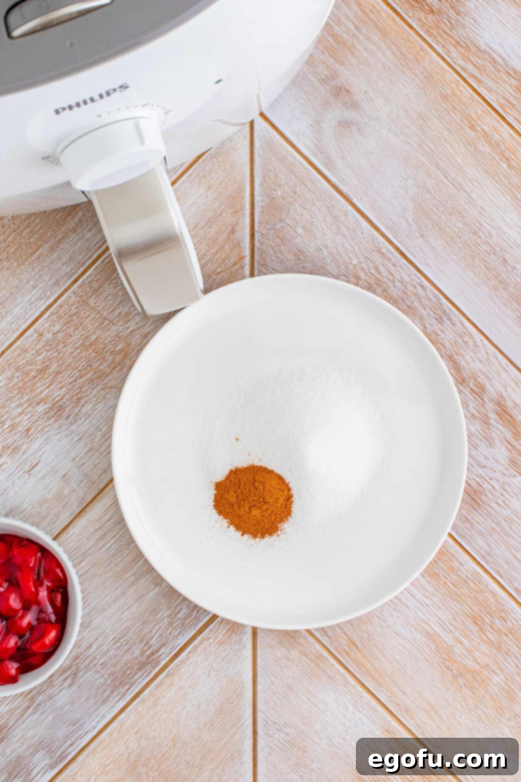 Cinnamon and sugar on white plate.