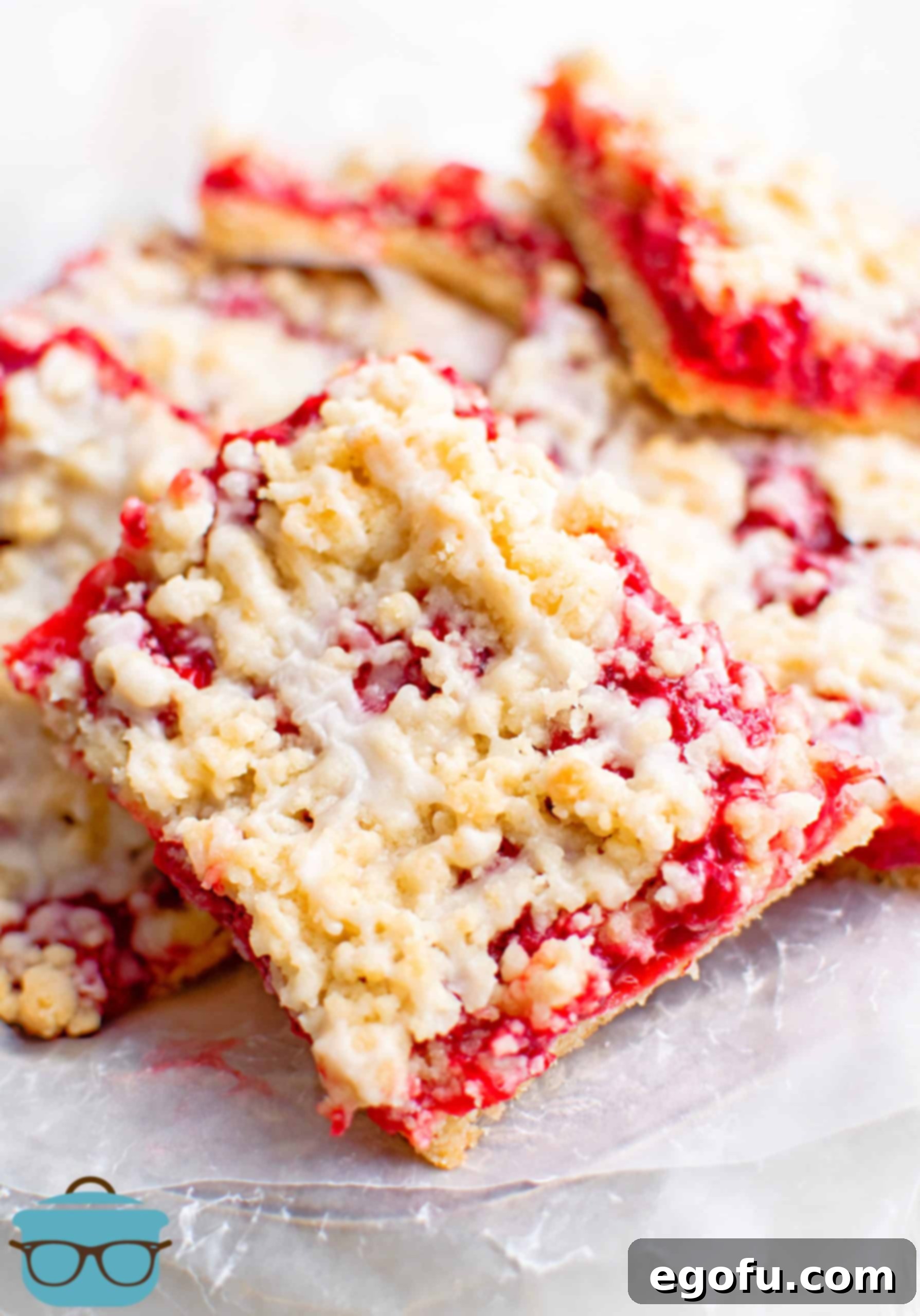 Golden Cherry Crumble Bars 2 Finished Cherry Crumble Bars stacked on parchment paper.